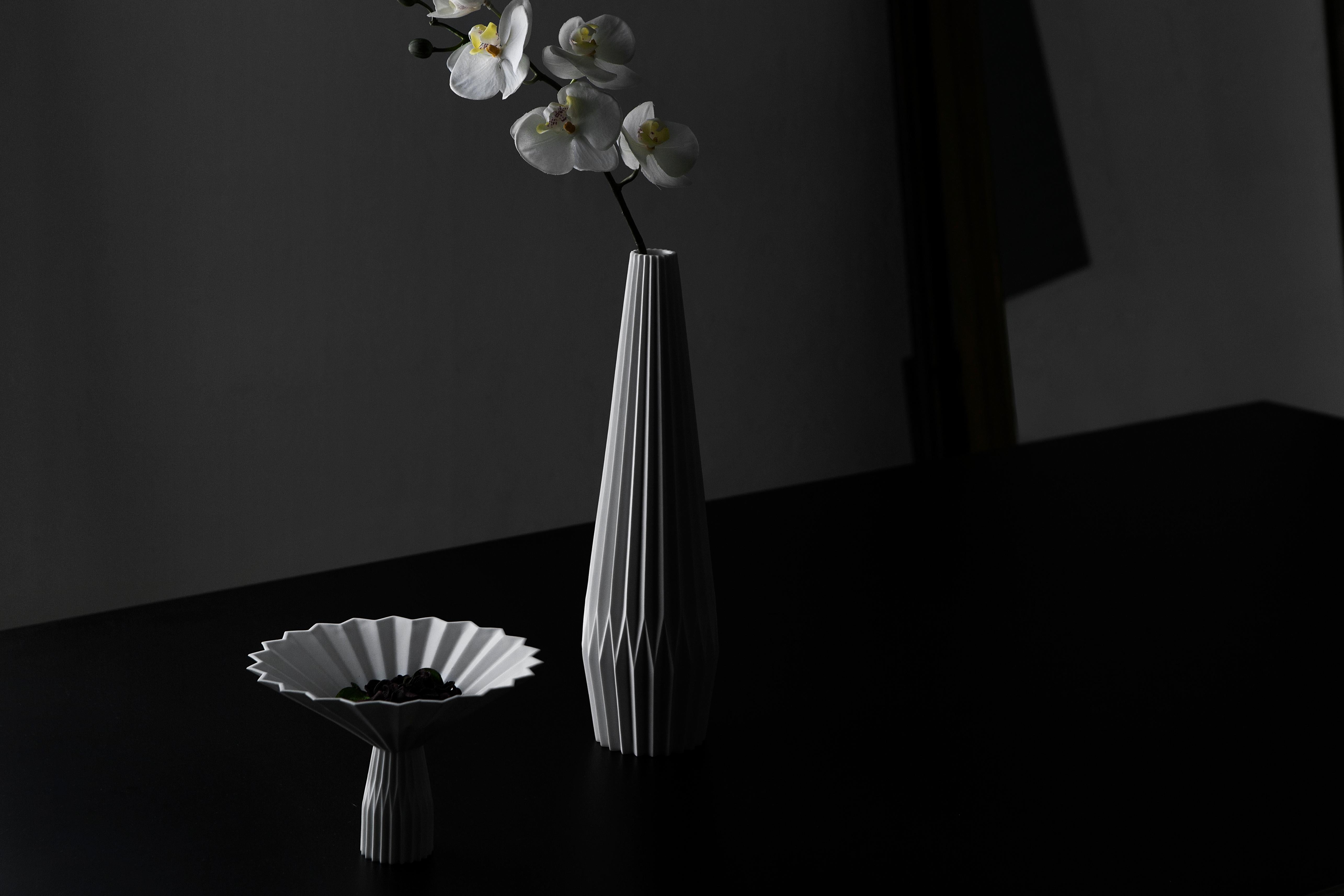 This centerpiece is designed by Denis Guidone and handmade in Japan by Risogama for Hands on design, a traditional pottery. It reminds the Japanese tradition of Origami, the designer uses the white Arita porcelain like paper and lighten the