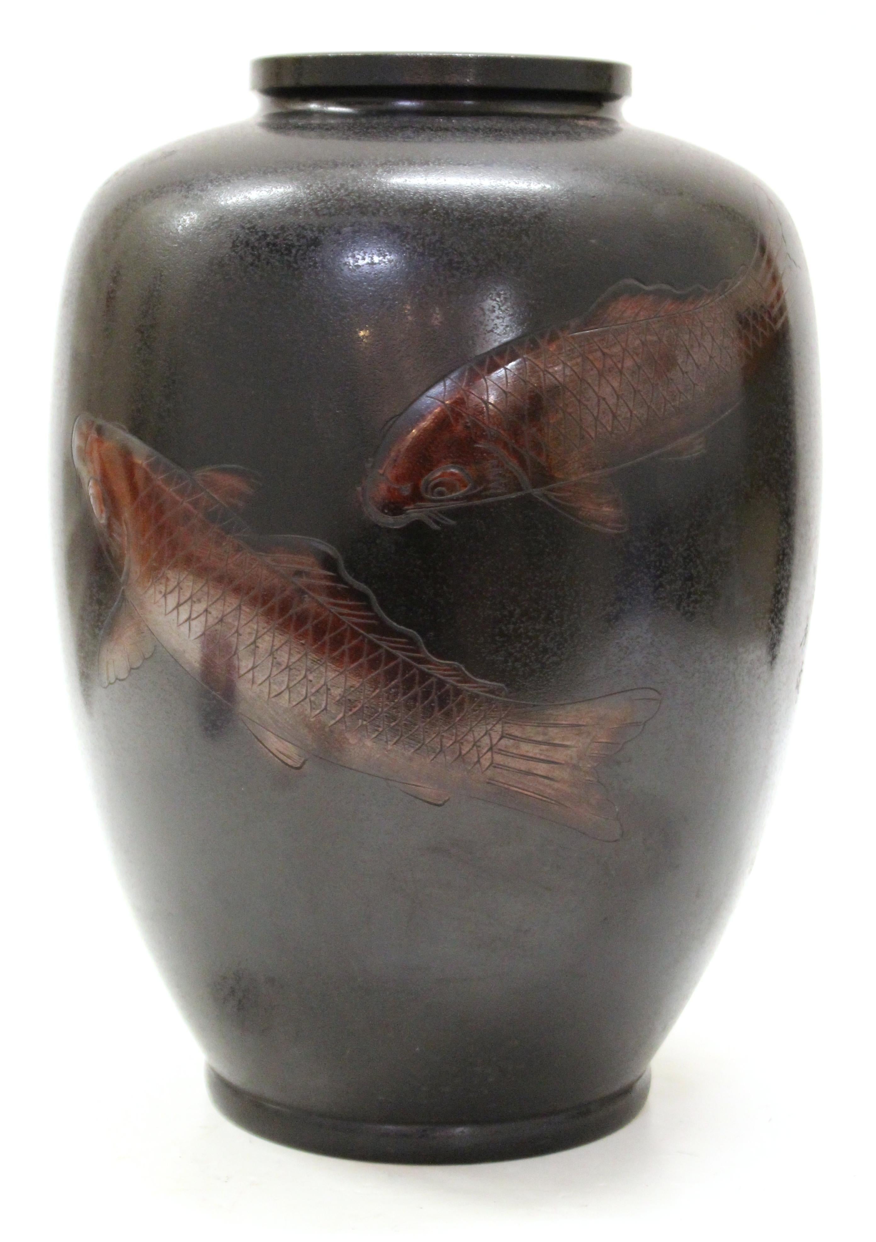Japanese Art Deco period heavy bronze vase with two swimming red carps on the front side. The piece was made in the 1930's and is signed twice, one signature on the side and another mark on the bottom. In great vintage condition with desirable