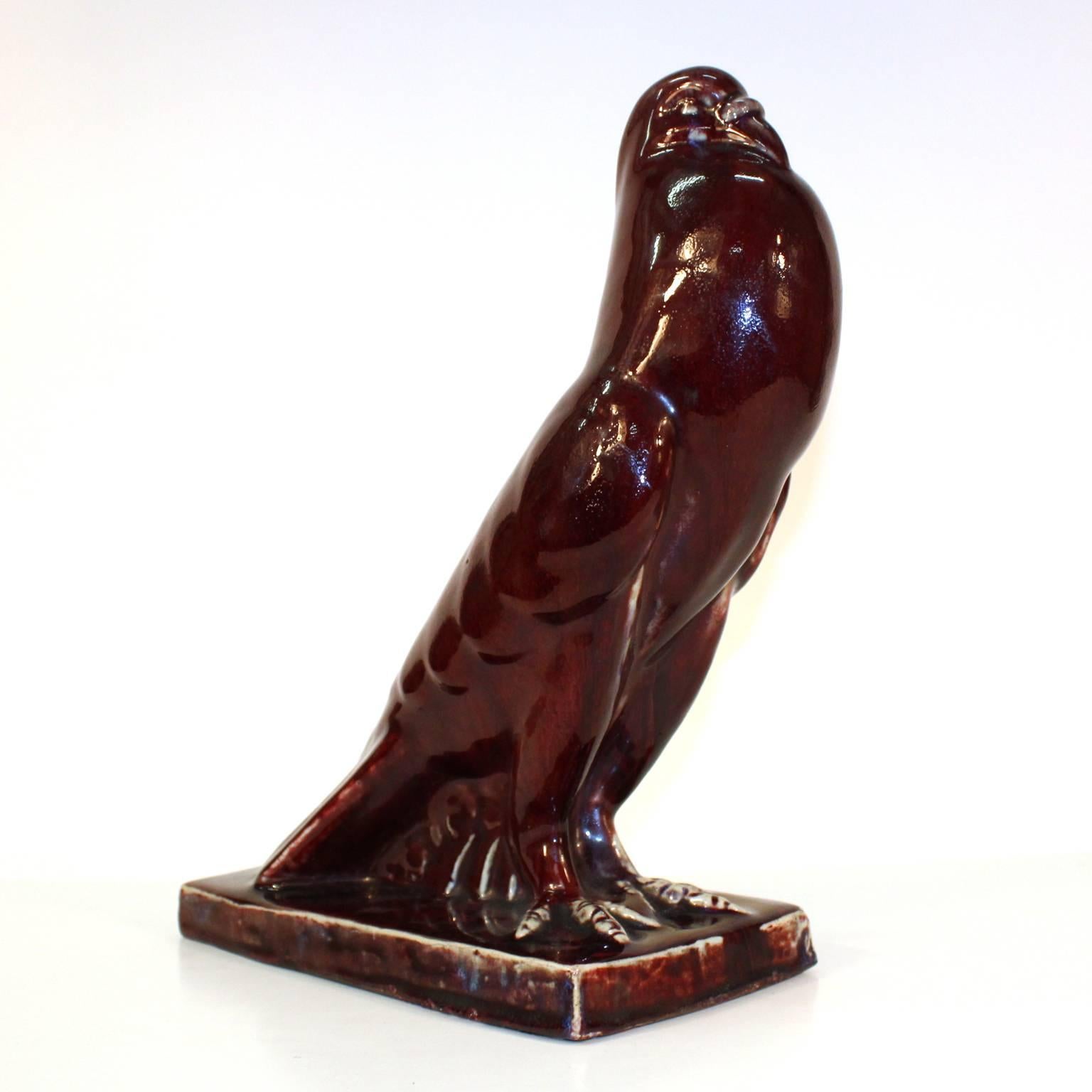 An Art Deco ceramic sculpture with ox blood colored glaze depicting a dove. Made in the 1920s-1930s in Japan for the French market. Excellent condition with paper label in Japanese; import piece. Japanese artist.