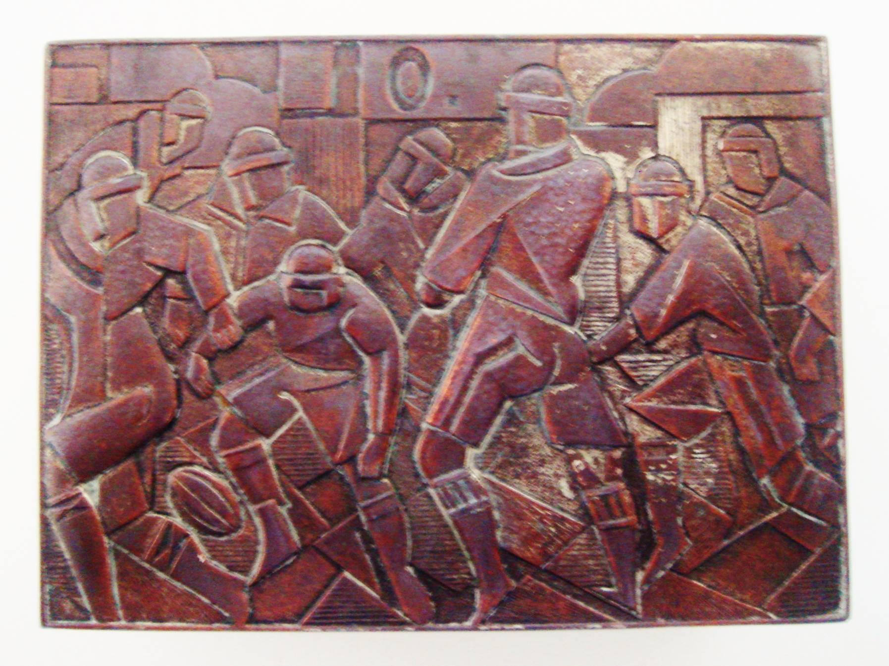 This Japanese Art Deco copper and nickel-plated spelter cigarette box with original cedar lining features the top and all four sides decorated with geometrically stylized sports scenes. The lid shows a football game with the players wearing the pre