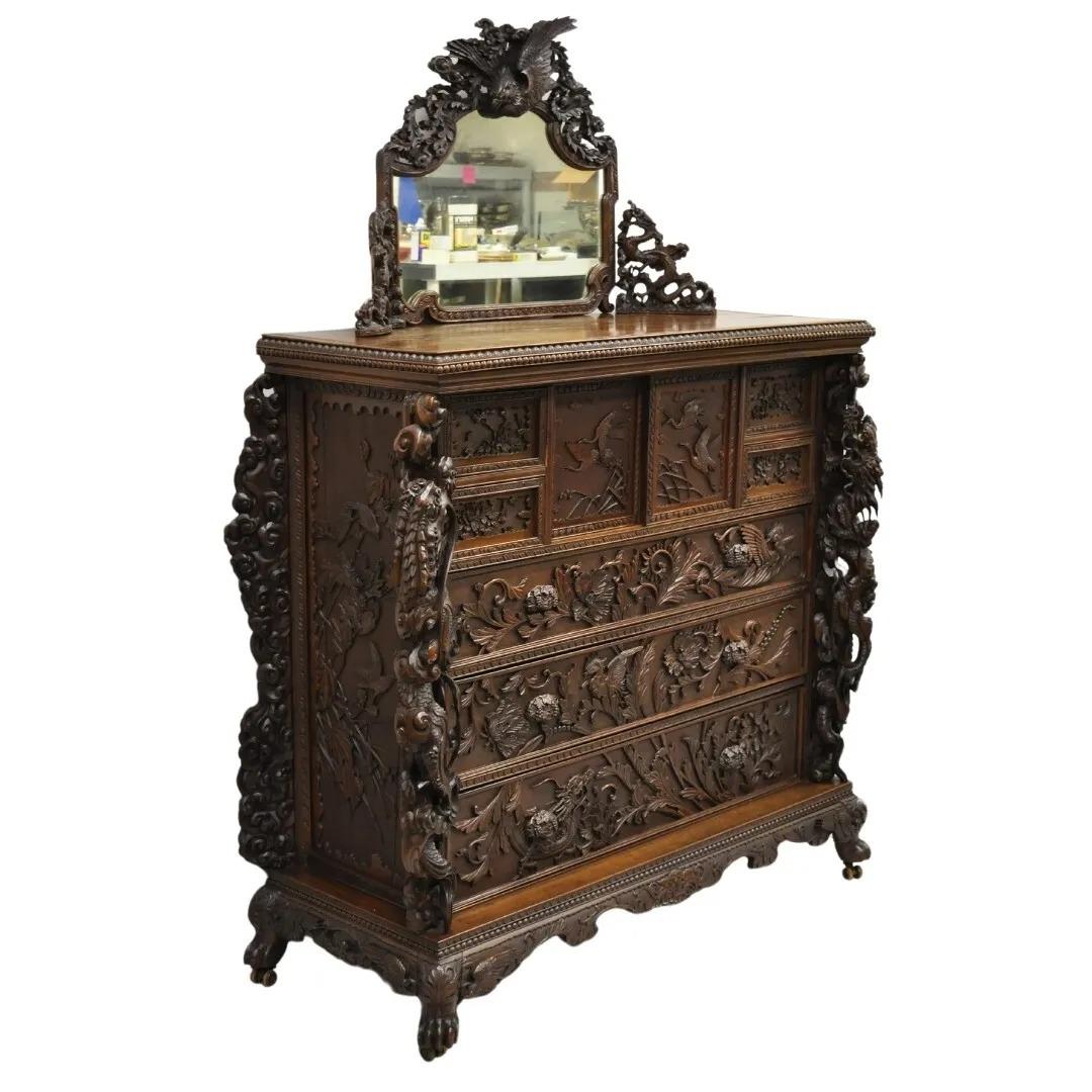 Antique Japanese Art Nouveau Dragon Carved Dresser Cabinet, Chest of Drawers w/ Mirror. Item features a relief carved mirror with central phoenix bird, dragons, and flowers. Chest further features 7 dovetail constructed drawers, 2 sliding doors with