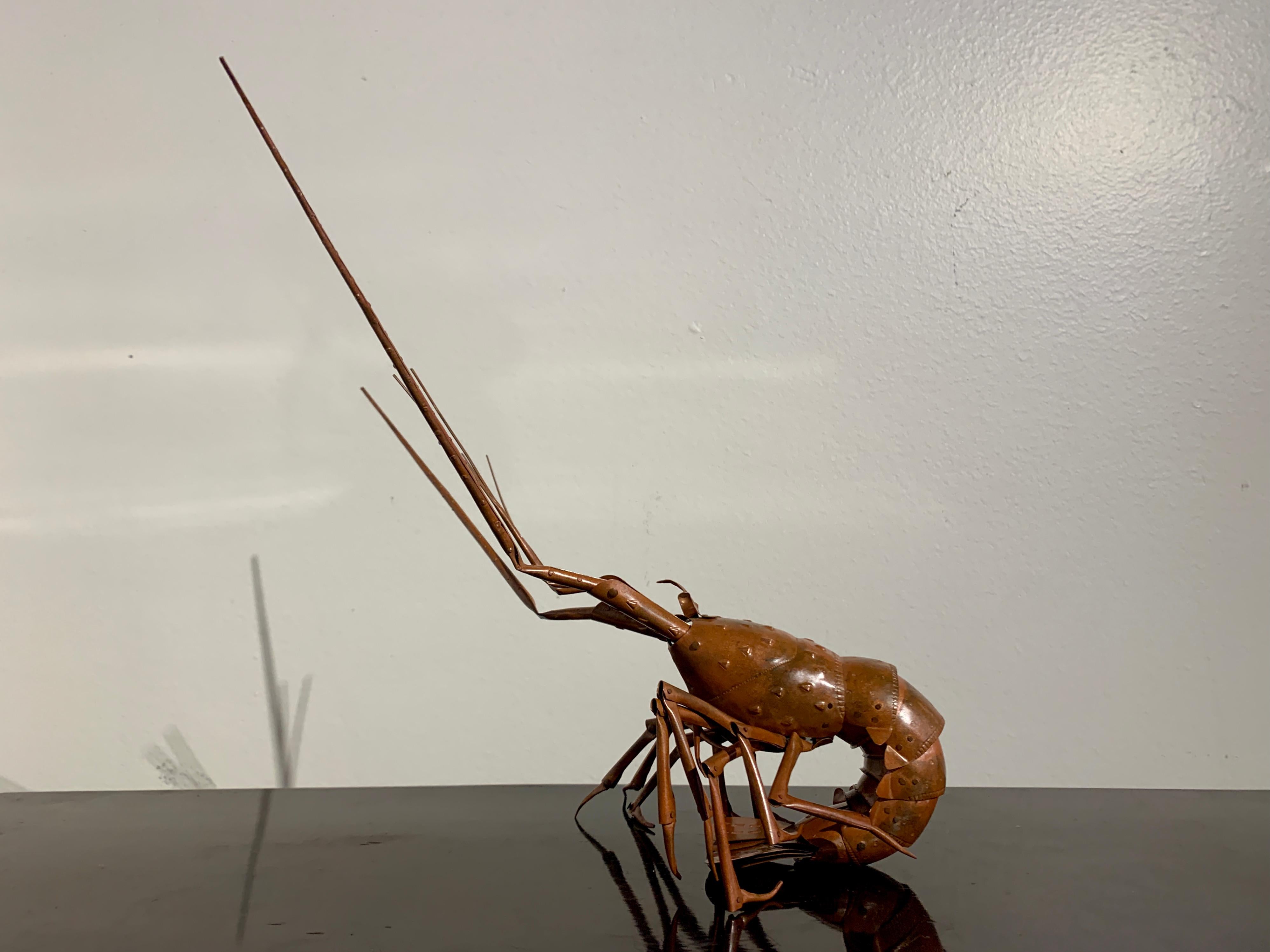 A fascinating and whimsical Japanese articulated model of a spiny lobster, jizai okimono, by Muneyuki Myochin, the fifty first head of the Myochin school of metal workers, Showa Era, mid 20th century, Japan. 

The spiny lobster ingeniously and