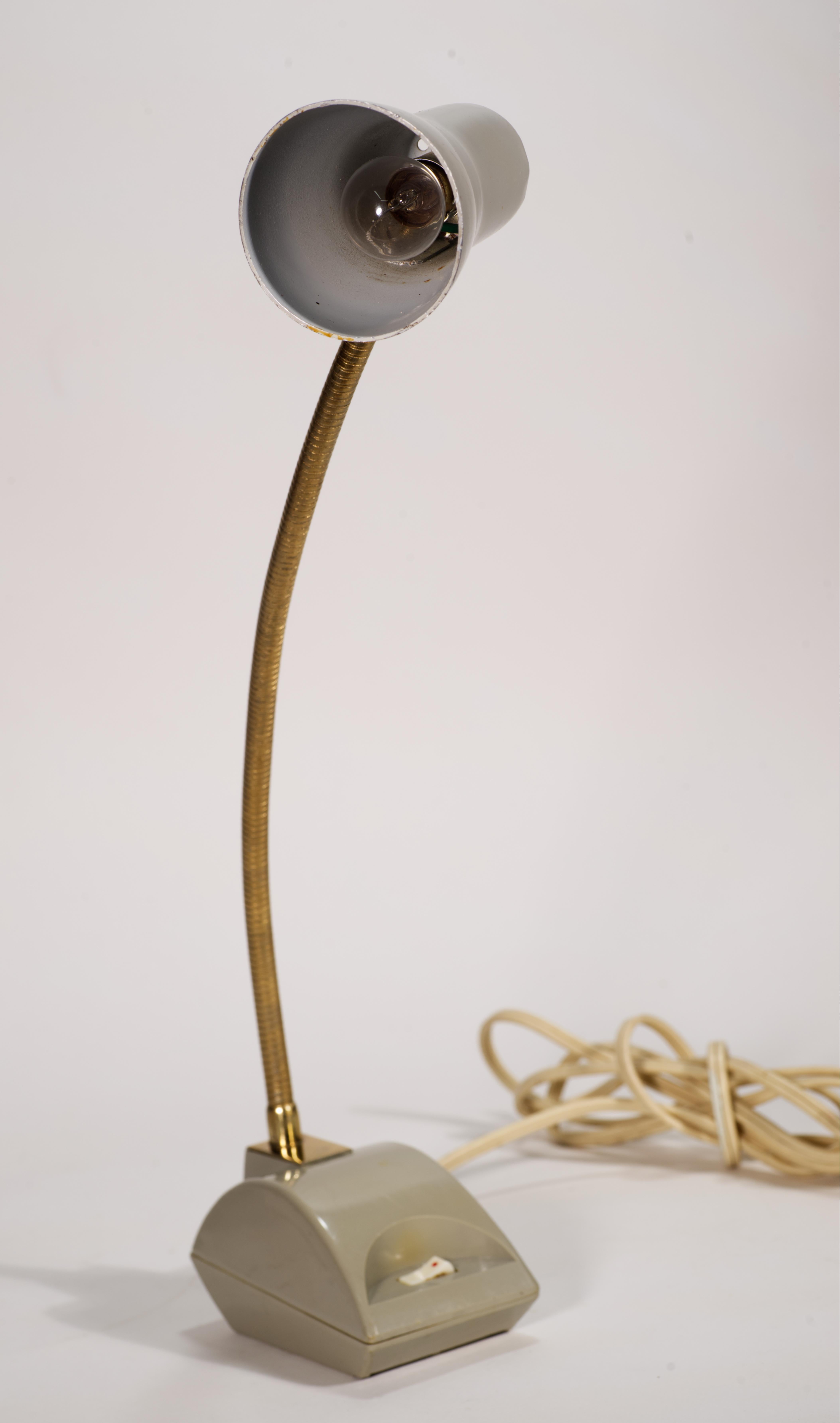 Cute little accent lamp from 1970s. Made by ImarFlex in Japan. 
Lamp can be used as a table or wall mounted. 
Bulb is a 12V  Incandescent single contact bayonet, available on line or in stores. 
There's a little wear on the enamel and gold on the