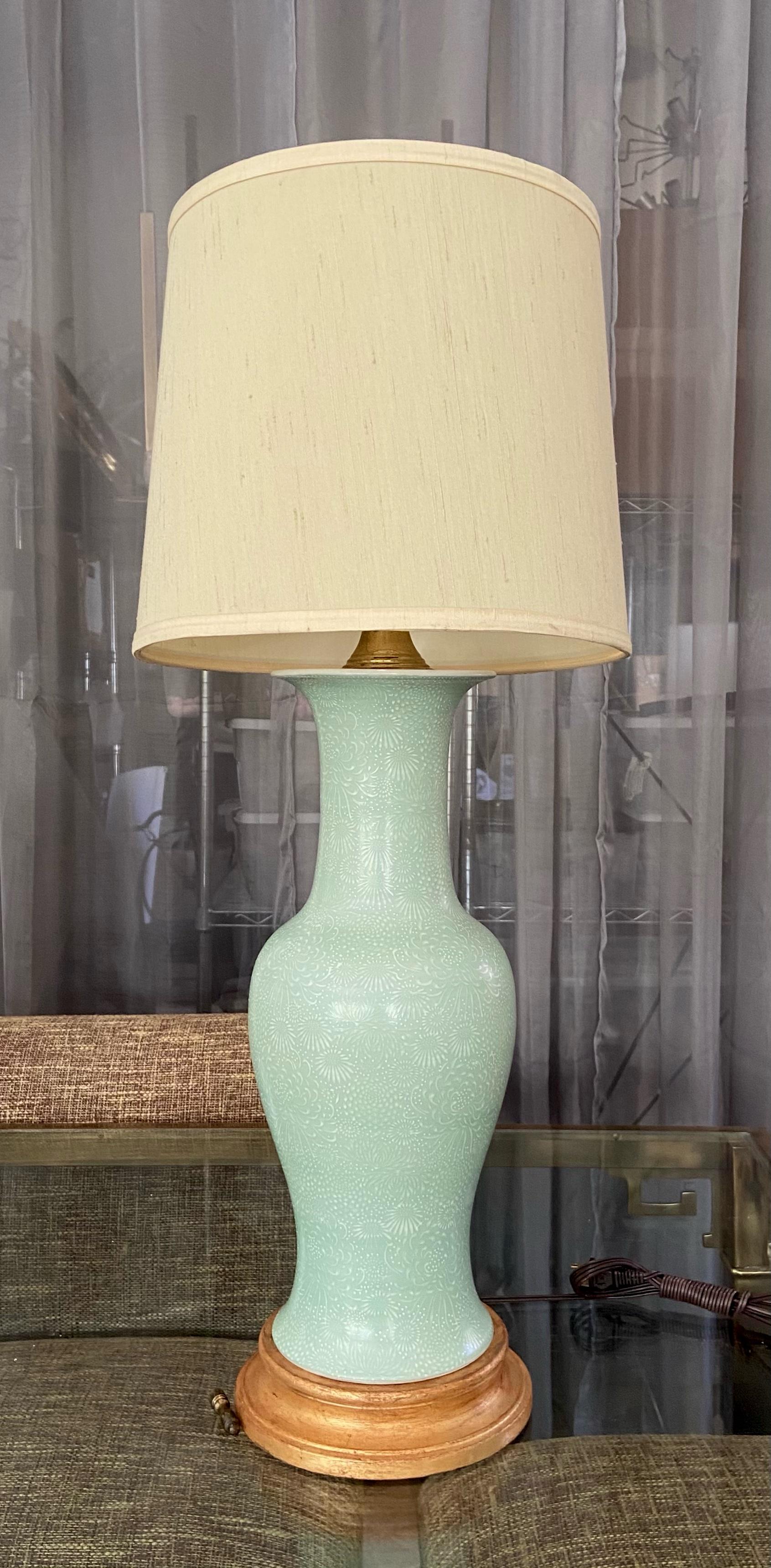 Single Japanese celadon green incised porcelain baluster form vase table lamp. Mounted on gilt turned wood lamp base. Newly wired with new 3 way socket and fittings. Porcelain vase portion is 18