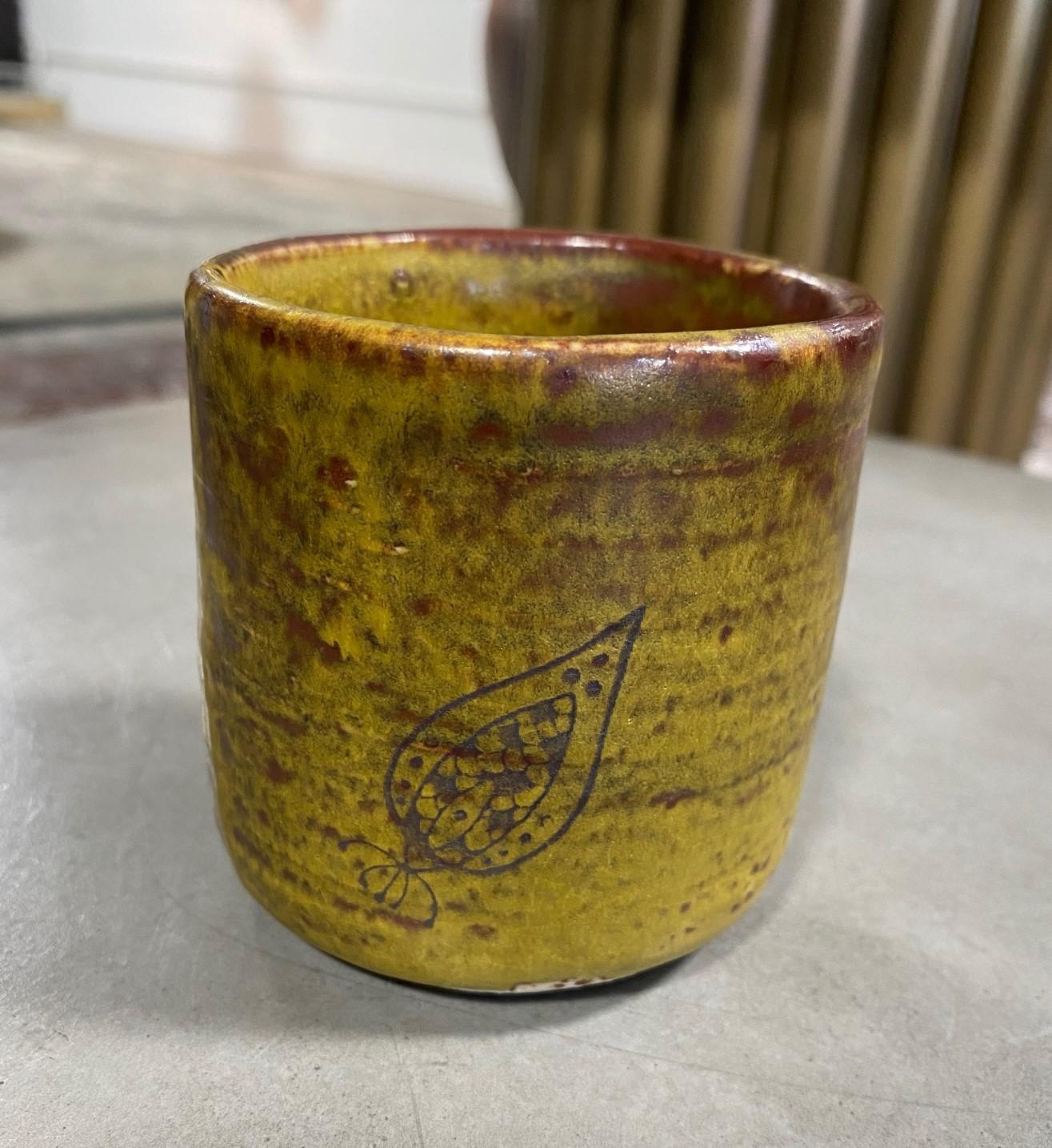 A beautiful Japanese yunomi teacup, richly glazed and featuring the artisan's signature creature figure painted on the cup.

This work (along with a second yunomi - clearly from the same artist. Please see the last image) came from a collector of