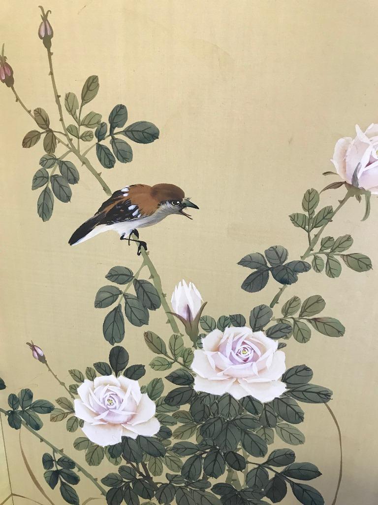 A four panel Japanese Byobu folding screen depicting a floral scene with playful birds

Original brass hardware for hanging

Signed and stamped by artist.

Approximate dimensions when fully extended: 36