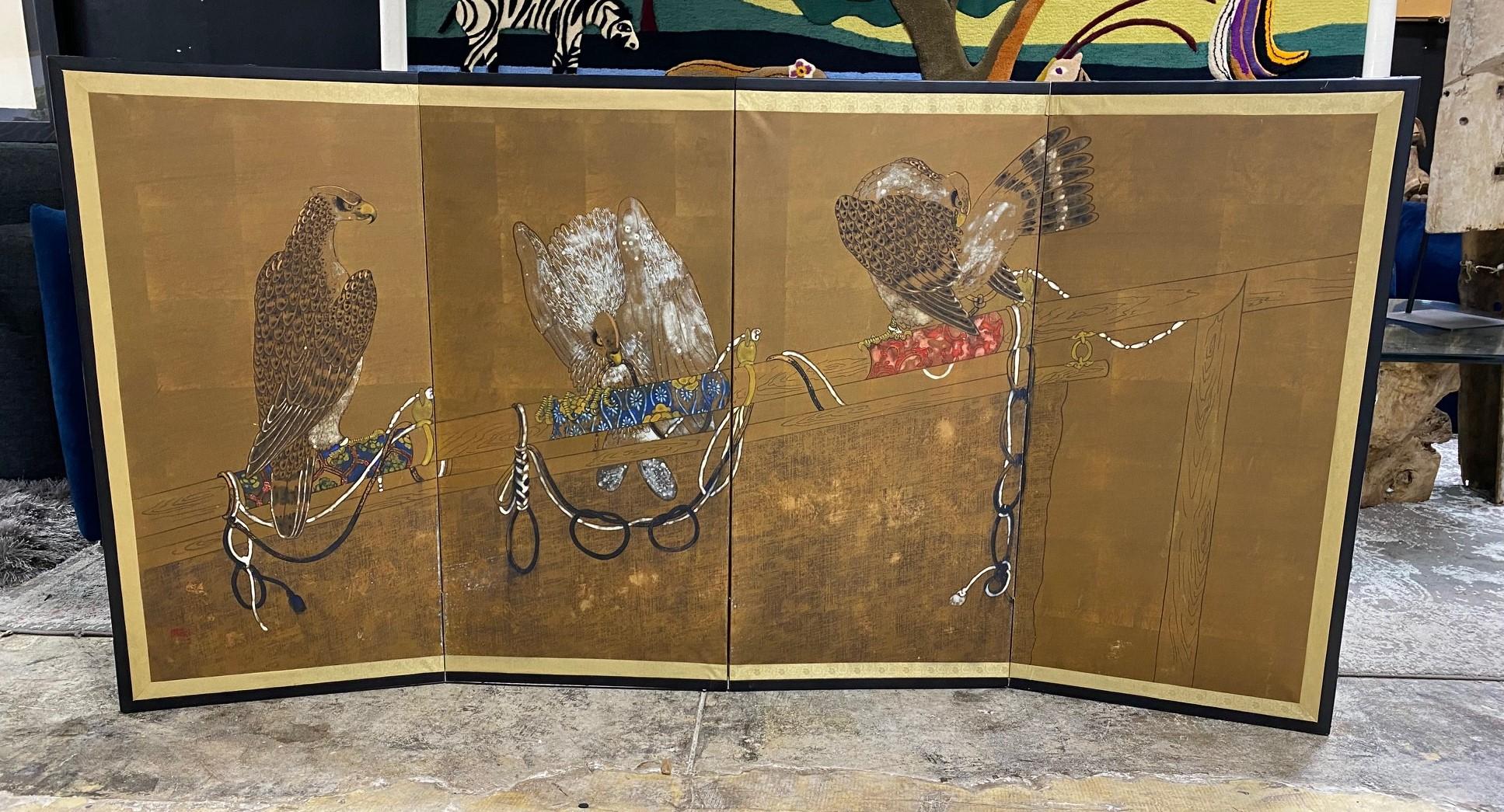 A beautiful and engaging four-panel Japanese Byobu folding screen depicting three distinct tethered and tamed hunting birds of prey - hawks or falcons (Takagari) - sitting upon their perch. The rich colors, gold leaf, and beautiful hand-painted