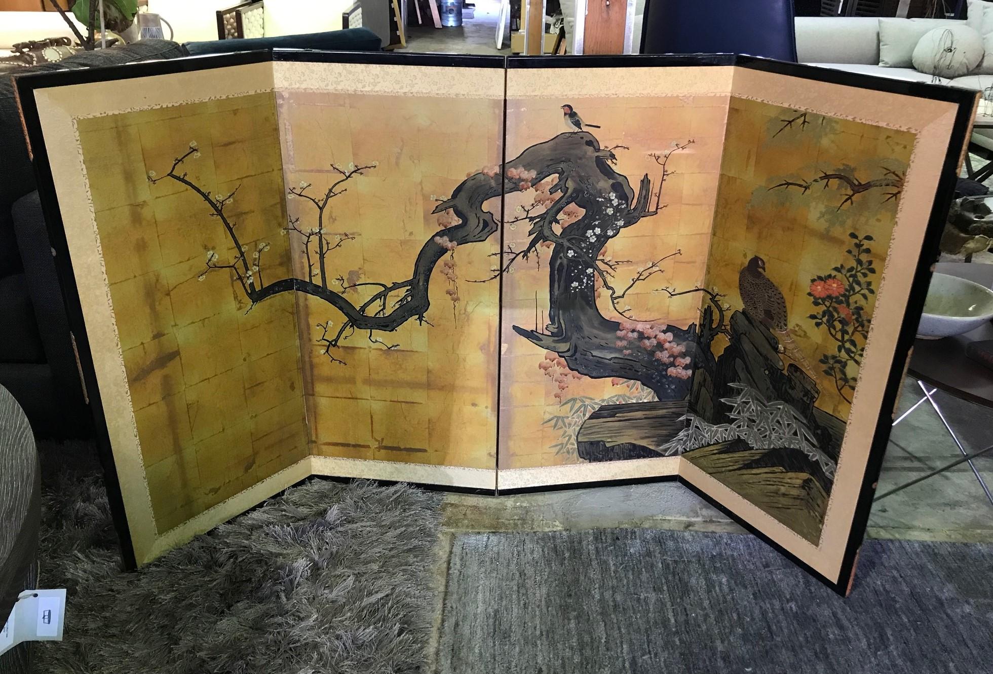 A truly beautiful four-panel Showa period Japanese Byobu folding screen depicting playful birds amongst a majestic blooming cherry tree branch. The shimmering gold leaf, rich colors and beautiful hand painted detail really makes this an attractive