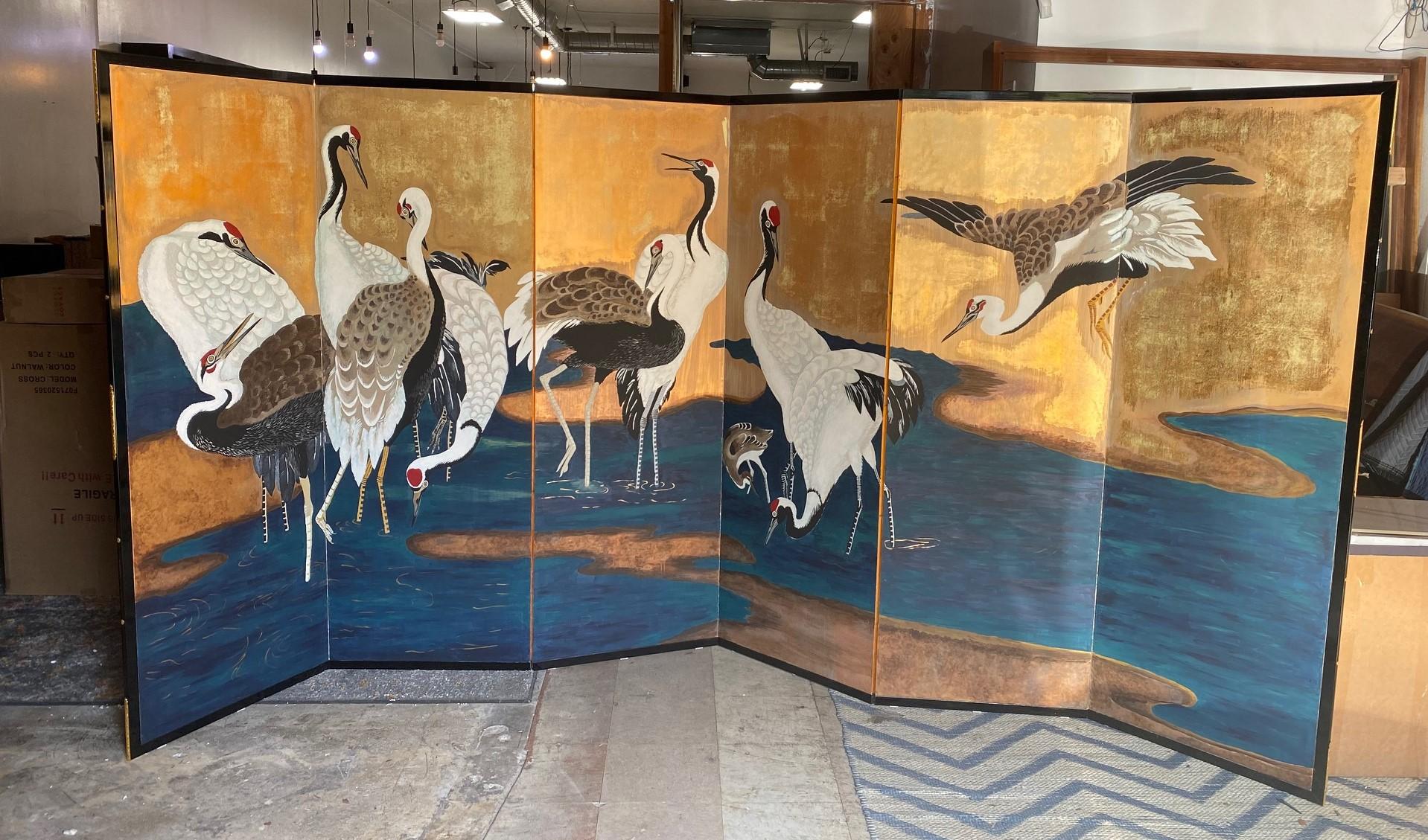 A gorgeous, very large six-panel Japanese Byobu folding screen depicting a group of cranes frolicking together in a stream/ lake. The beautiful, bold colors and hand-painted detail really make this an attractive and special work. The whole scene -