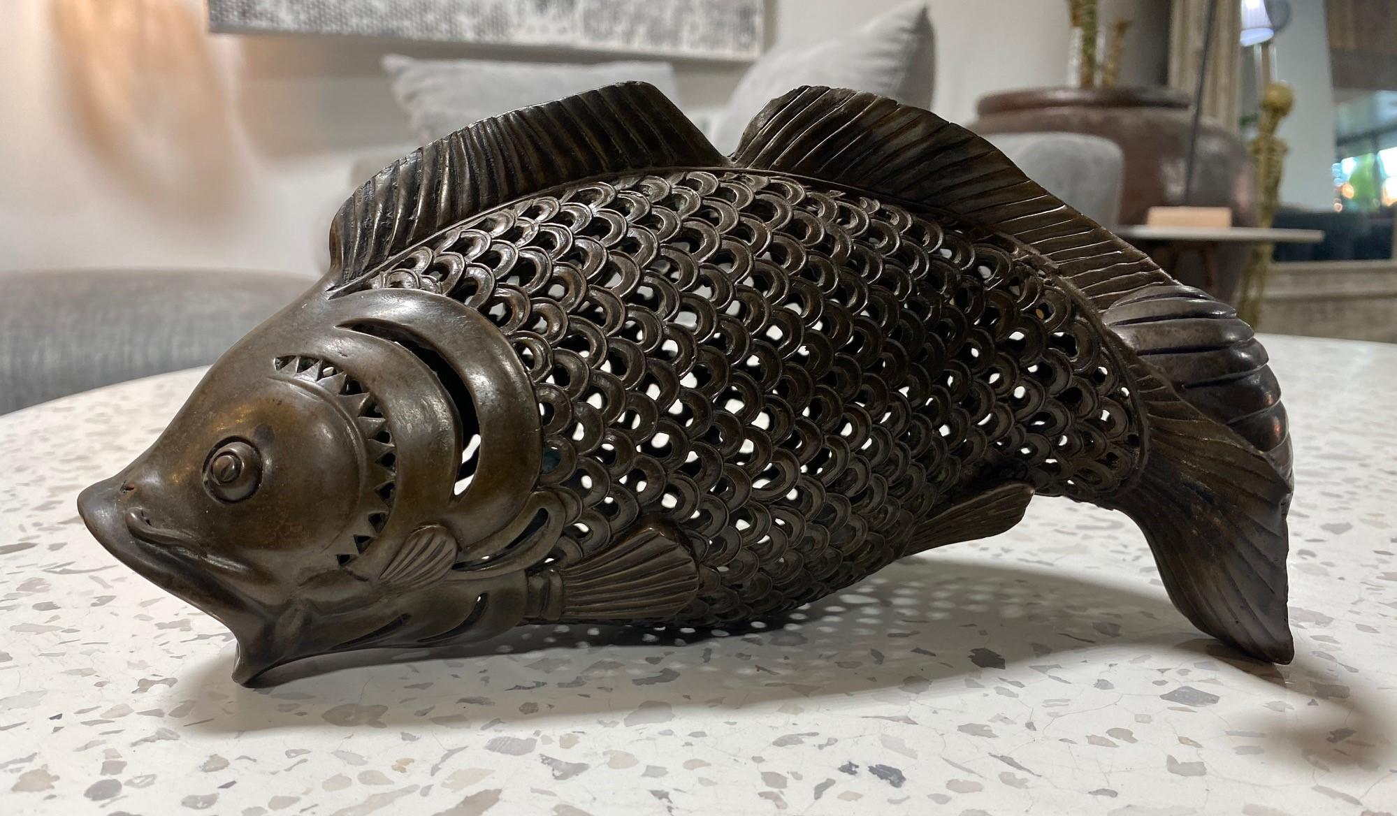 A beautiful Japanese bronze koi fish sculpture with wonderful mesh craftsmanship and a glowing patina. 

This piece may have initially been made to use as an incense burner or decorative hanging ornament in a traditional Japanese kitchen/ Irori