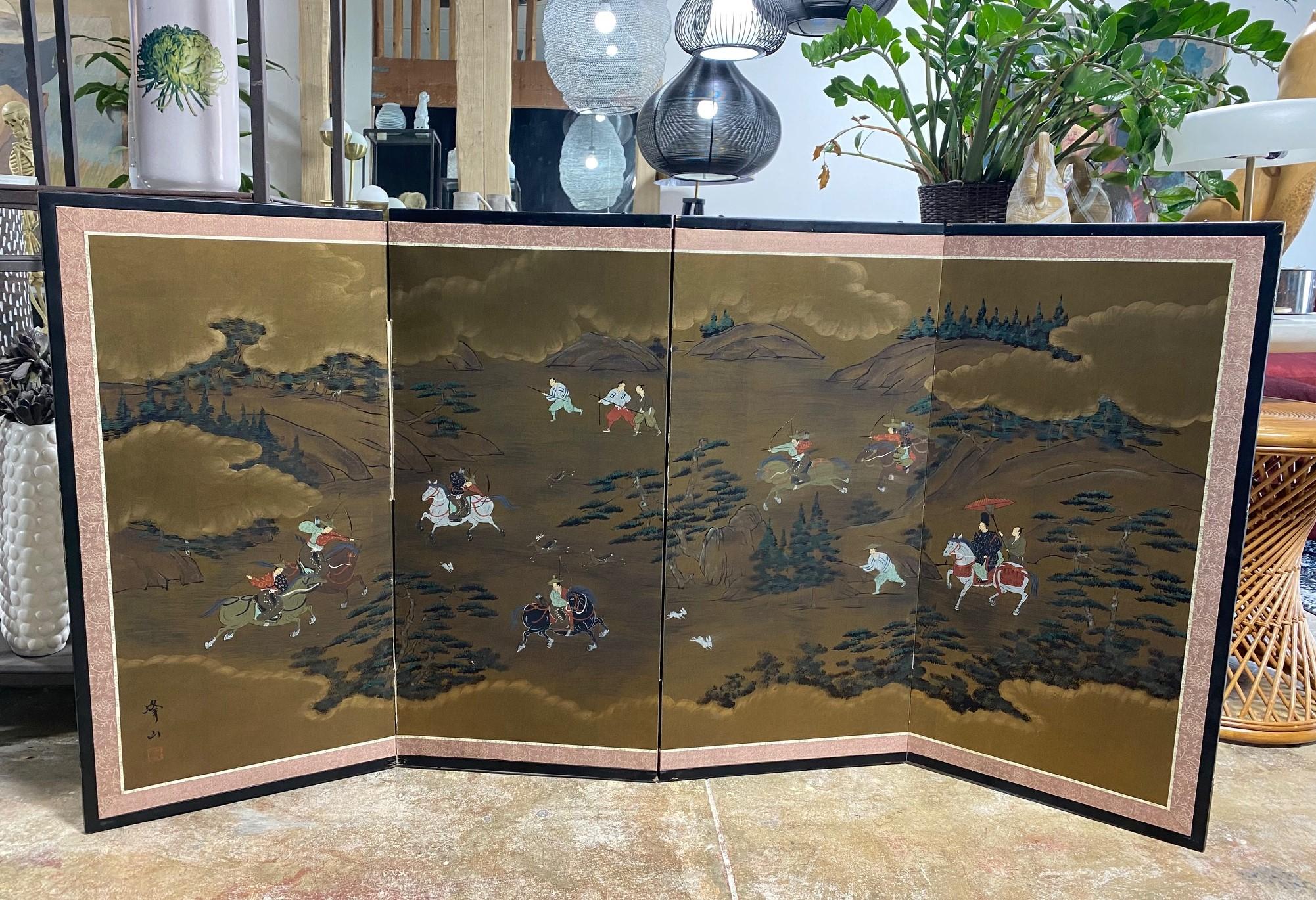 A gorgeous four-panel Japanese Byobu folding screen depicting a hunting scene with various warriors and animals spread across a vast, mountainous landscape with lush forest. The dark, rich colors, gold leaf, and beautiful hand-painted detail really