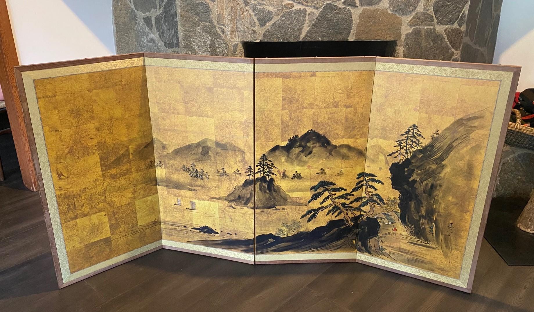 A gorgeous four-panel Japanese Byobu folding screen depicting a natural landscape scene with a small village and boats on the shimmering water. The dark, rich colors, gold leaf, and beautiful hand-painted detail of the surrounding mountainous