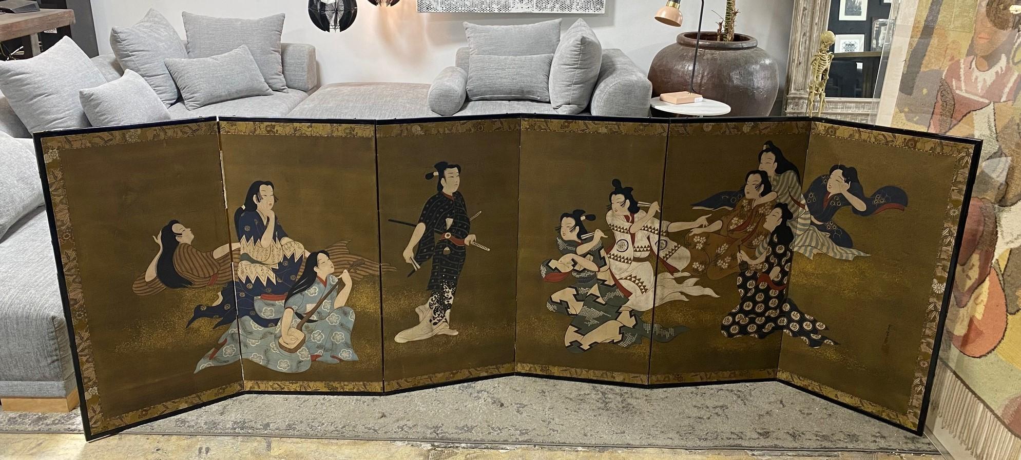 A gorgeous, quite fascinating hand-painted six-panel Japanese Byobu folding screen depicting a rather engaging androgynous or erotic court scene (it has been suggested to us that this could be a lesbian party). The central figure and characters on