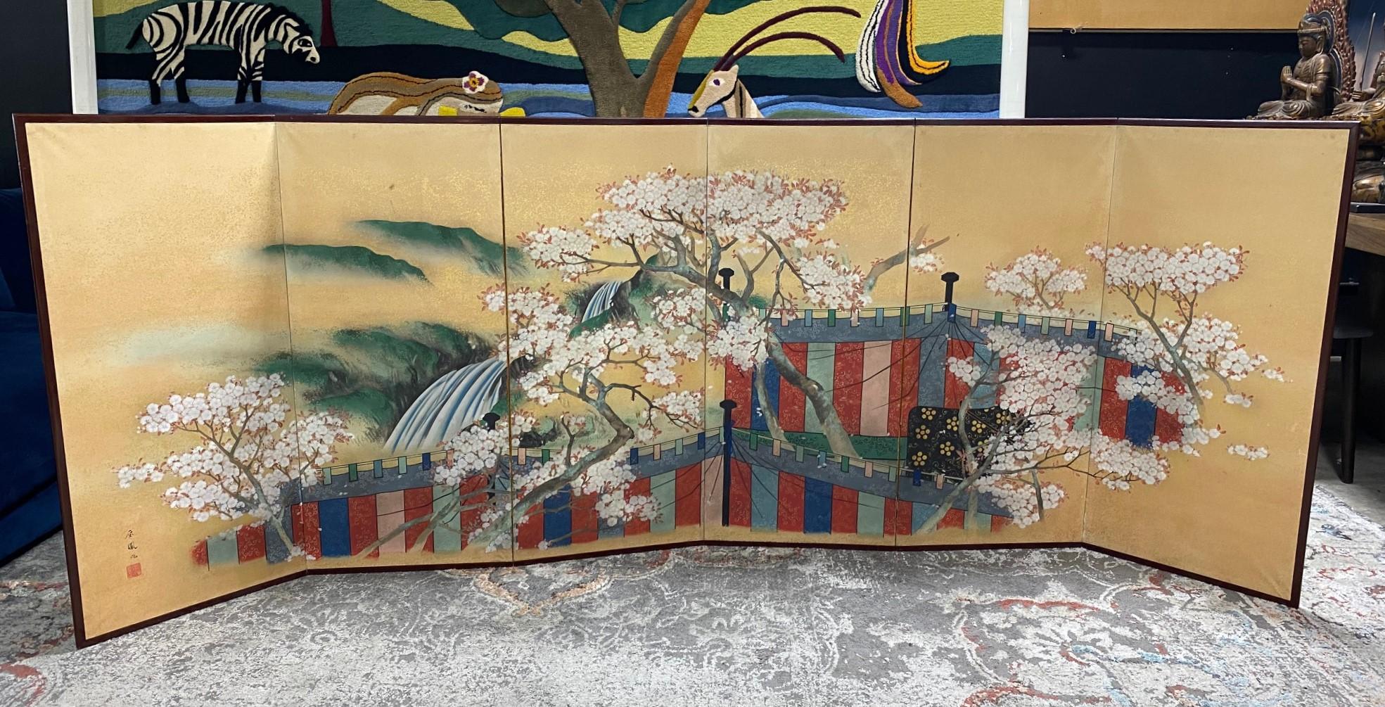 A gorgeous six-panel Japanese Asian Byobu folding screen depicting a cherry blossom viewing pavilion/picnic scene. The colorful cloths are privacy curtains arranged for an exclusive party or gathering most likely for an esteemed nobleman and his