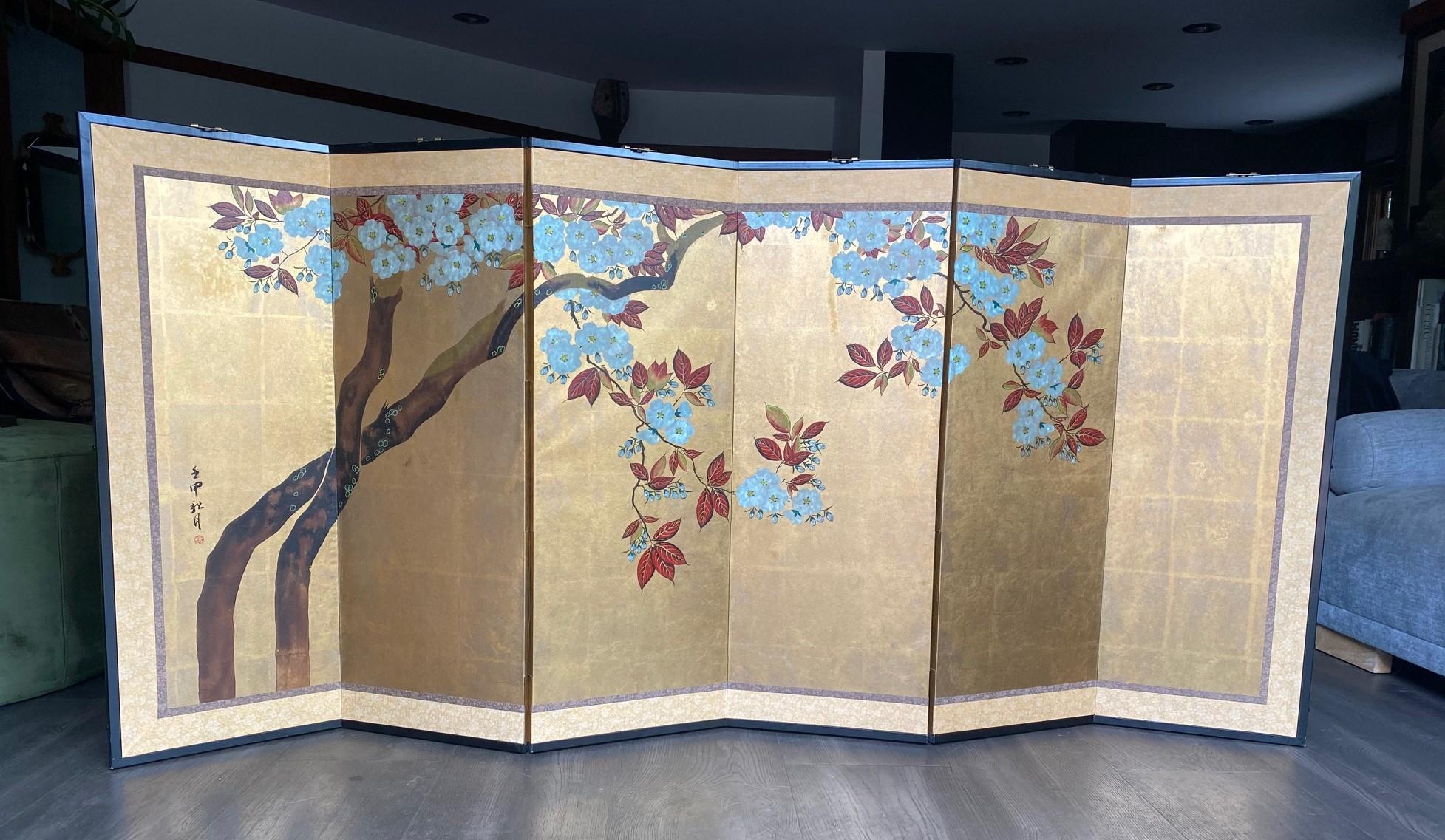 A gorgeous six-panel Japanese Byobu folding screen depicting a cherry blossom tree in full bloom.. The vibrant, rich colors, gold leaf, and beautiful hand-painted detail of the tree and cherry blossom flowers make this quite an attractive