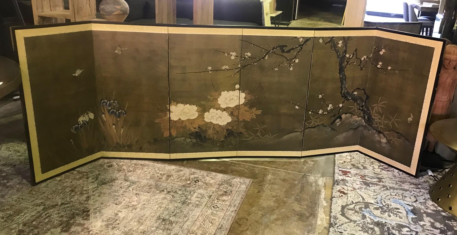 A gorgeous six-panel Japanese Byobu folding screen depicting a nature scene with cherry blossoms, flowers, and playful birds. The dark, rich colors, gold leaf, and beautiful hand painted detail of the natural wildlife and floral population really