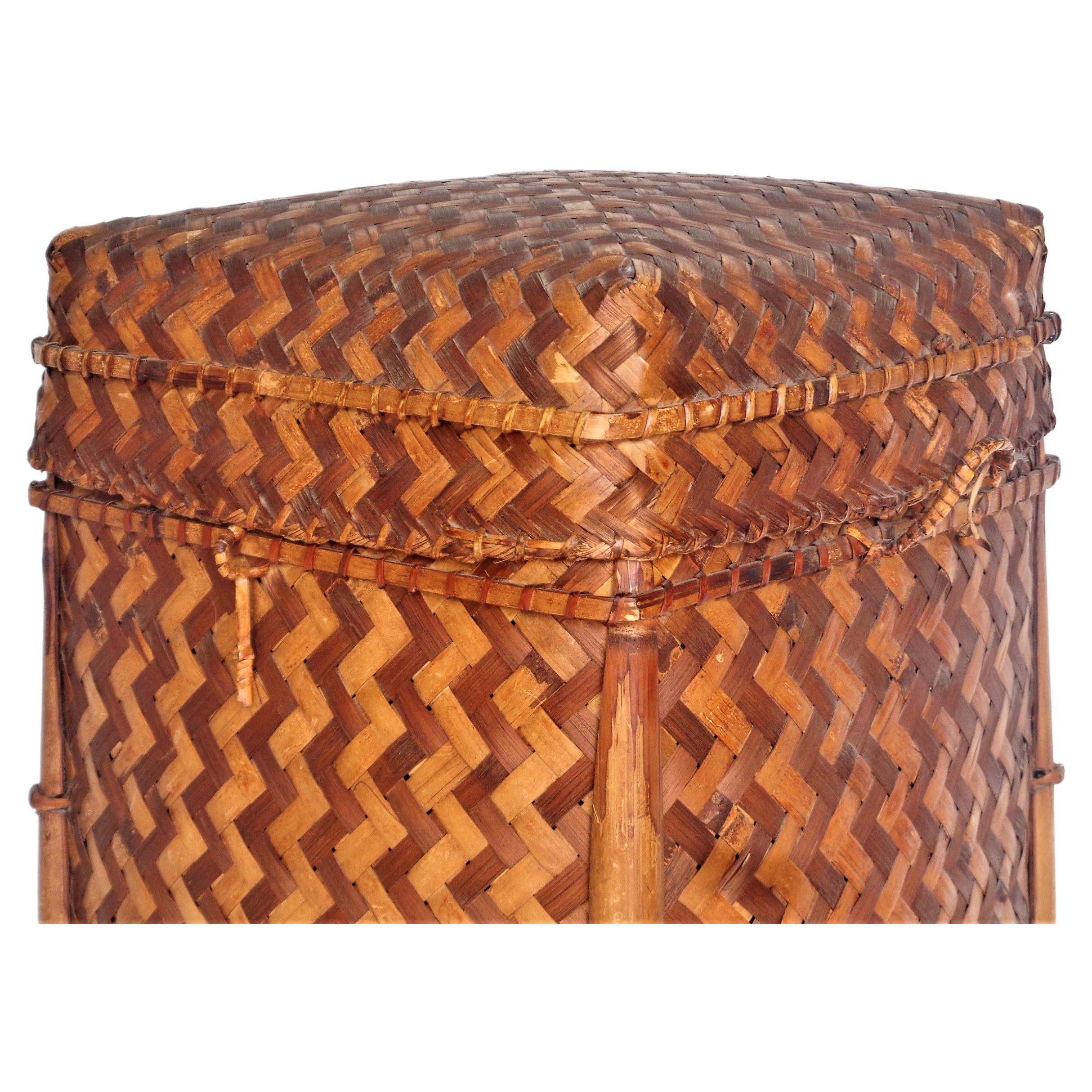 Japanese bamboo and two tone herring bone weave rattan lidded storage basket. Reed wrapped loop at front / reed wrapped handles at both sides / reed wrapped hinges at back. All over beautifully aged original surface color patina. Circa 1960. Look at