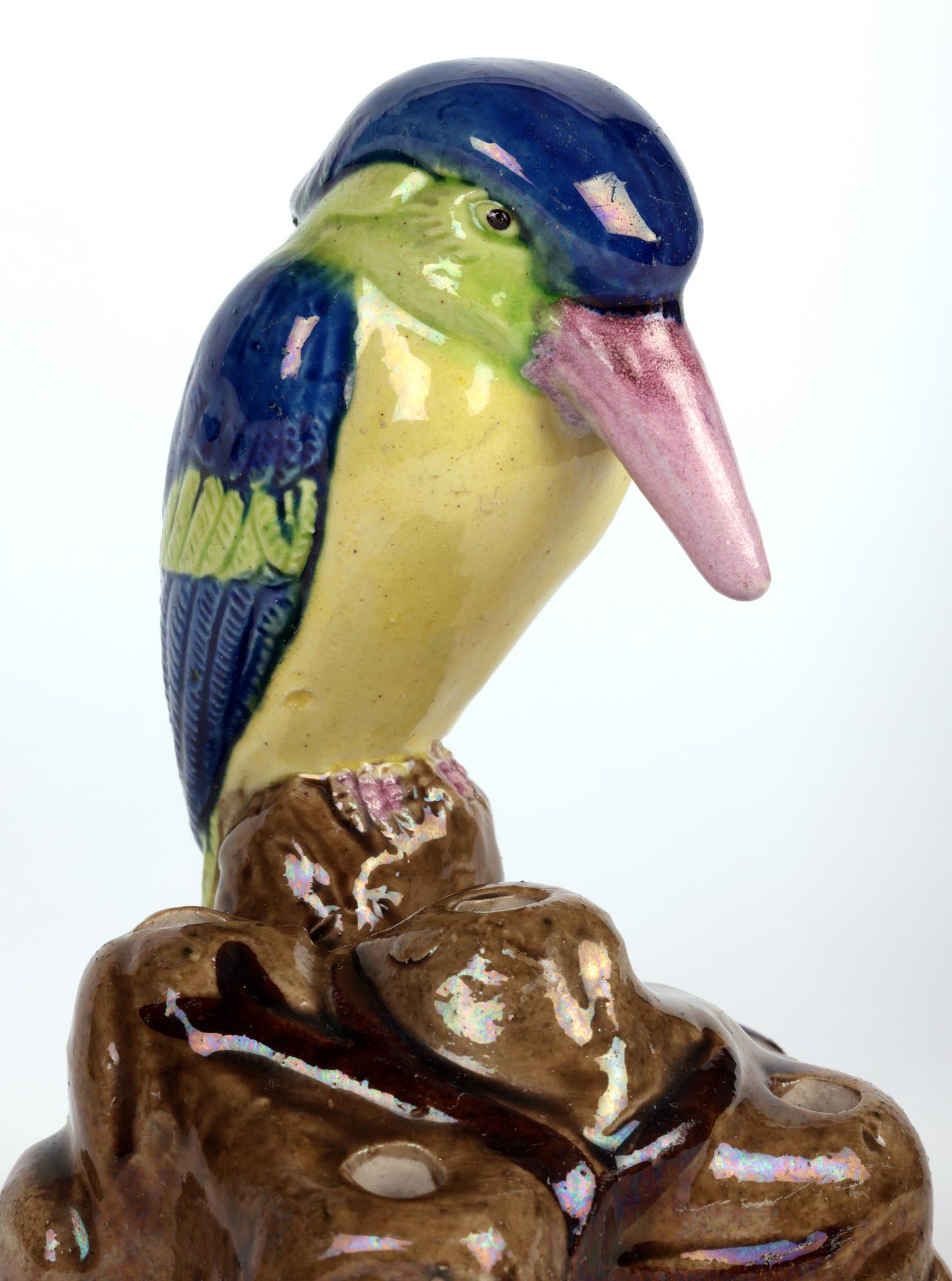 A very fine and unusual Art Deco Japanese Banko Ware pottery hatpin holder mounted with a large crested bird and dating from around 1920. The earthenware holder is modelled as a bird perched on a rocky mound applied with branches with a series of