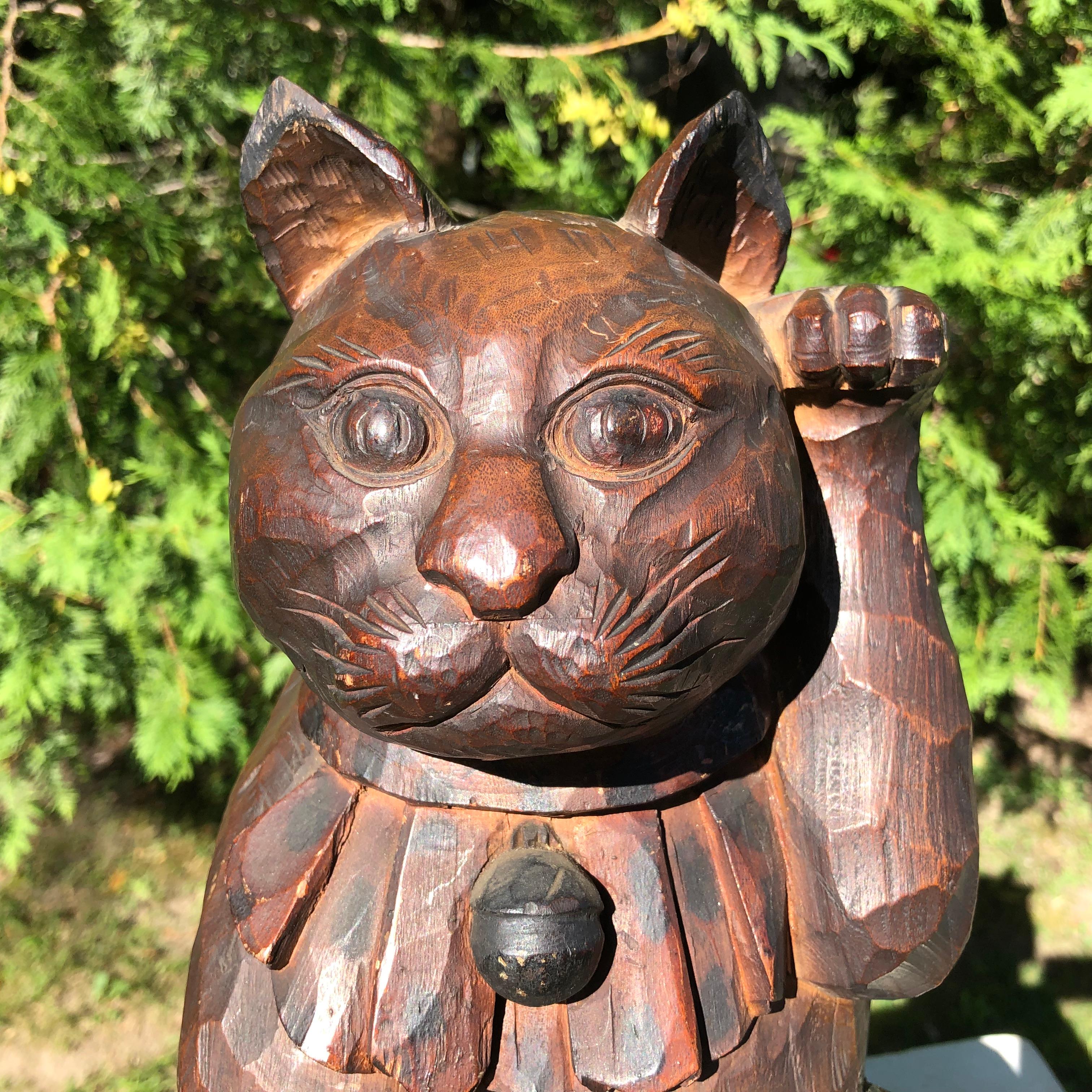 Japan a rare large scale and lovely hand carved and hand-lacquered wooden Maneki Neko good fortune money cat. It is exquisitely carved in a Classic Japanese one piece 
