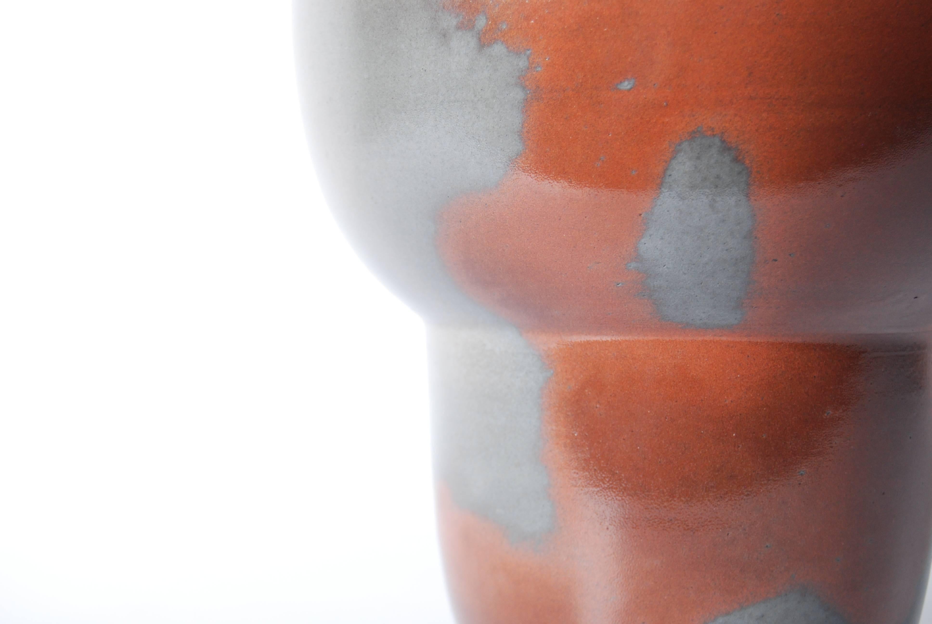 This elegant water jar for tea ceremony (Mizusashi), from the Okayama prefecture of Japan features striking mottled tones of grey and rust which are the result of charcoal ash staining the pottery during the 8-day wood-kiln firing process. 

As one