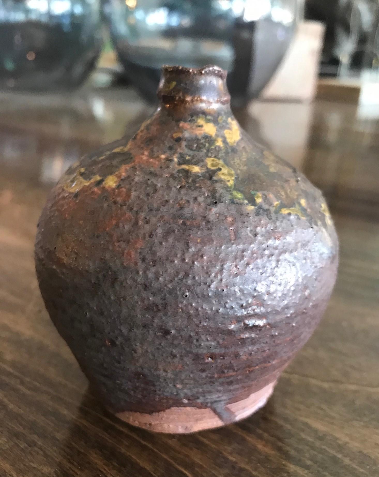 A wonderful gem of a piece. Beautifully fired and colored.

Japanese Bizen-Yaki pottery which dates back hundreds of years (its heyday was in the 16th century) is recognizable by its rustic quality and imperfections that were said to mirror those