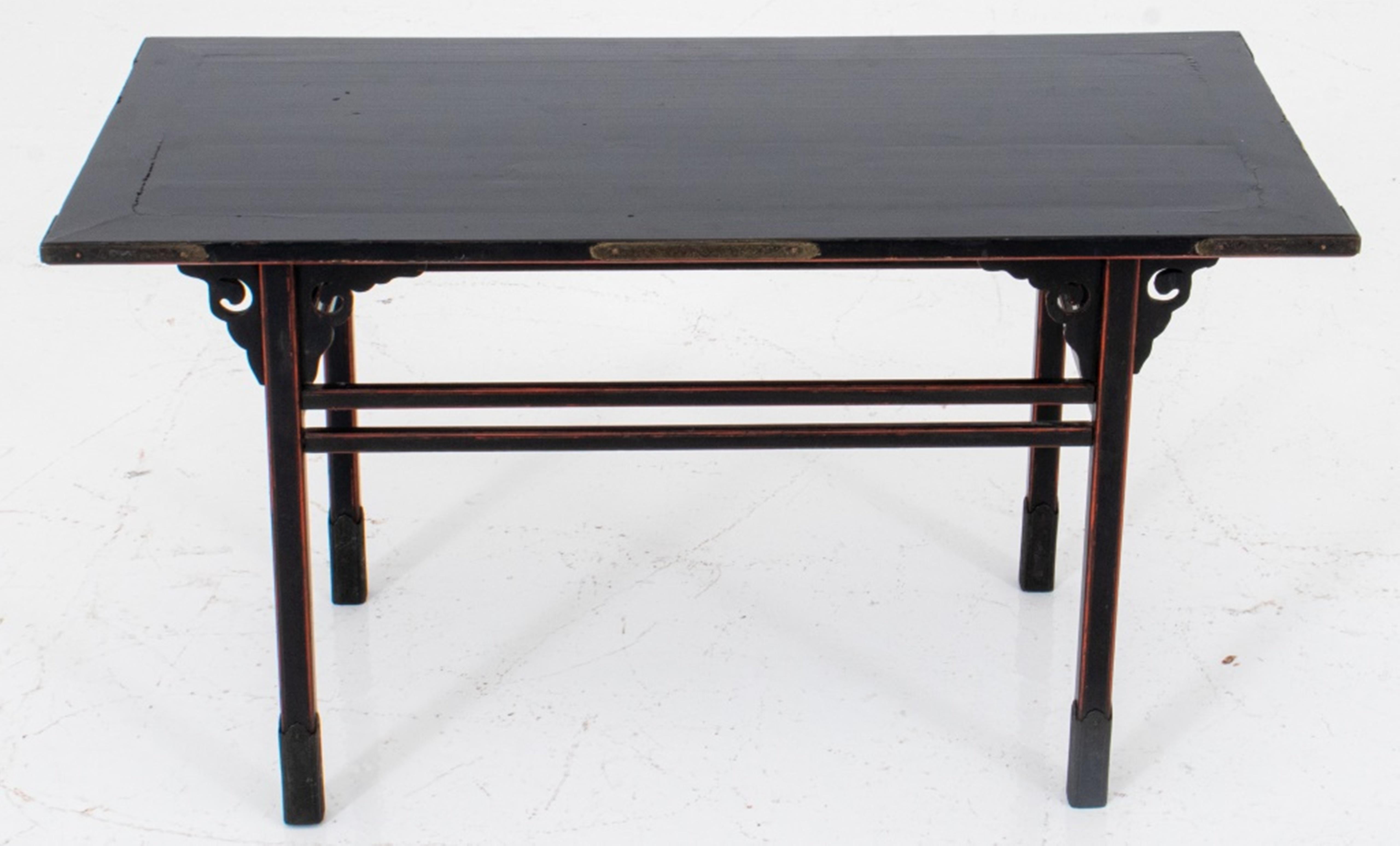 Japanese black lacquer alter table with cloud-form joints, red painted borders,
and incised patinated metal decoration, nineteenth century. 13.5