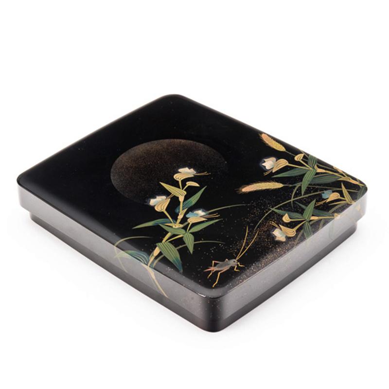 Japanese black lacquer Tsuzuri-Bako (writing box) with a delicate and whimsical design of a cricket and grasses illuminated by the gentle gaze of the full moon, circa 1960.
Inside the box are mounted a suiteki (water pourer) and a suzuri (ink
