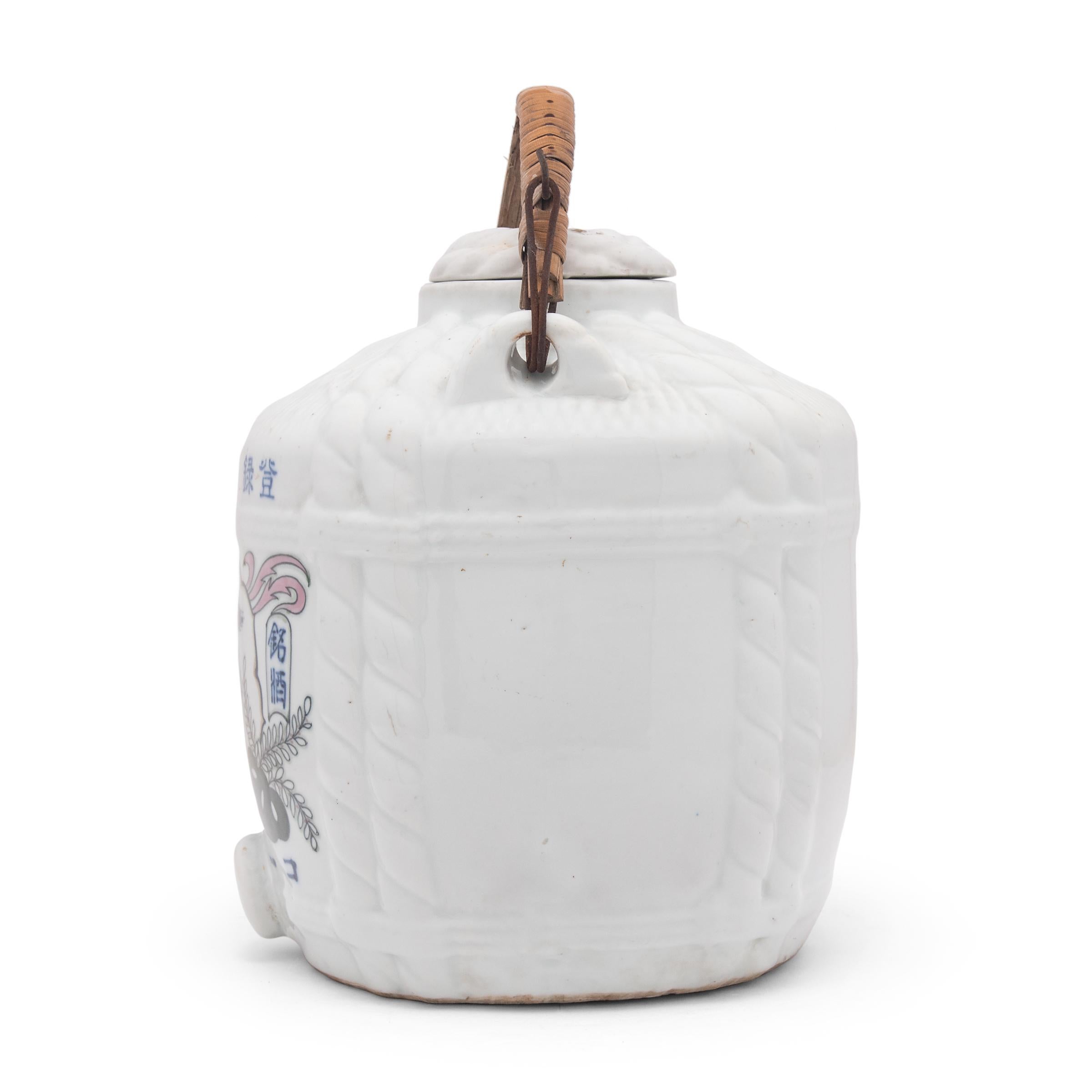 This large porcelain jar is a vintage Japanese sake keg dated to the early 20th century. Known as taru or daru, large sake casks such as this are often saved for special occasions such as New Year's celebrations. The jar has a molded shape designed