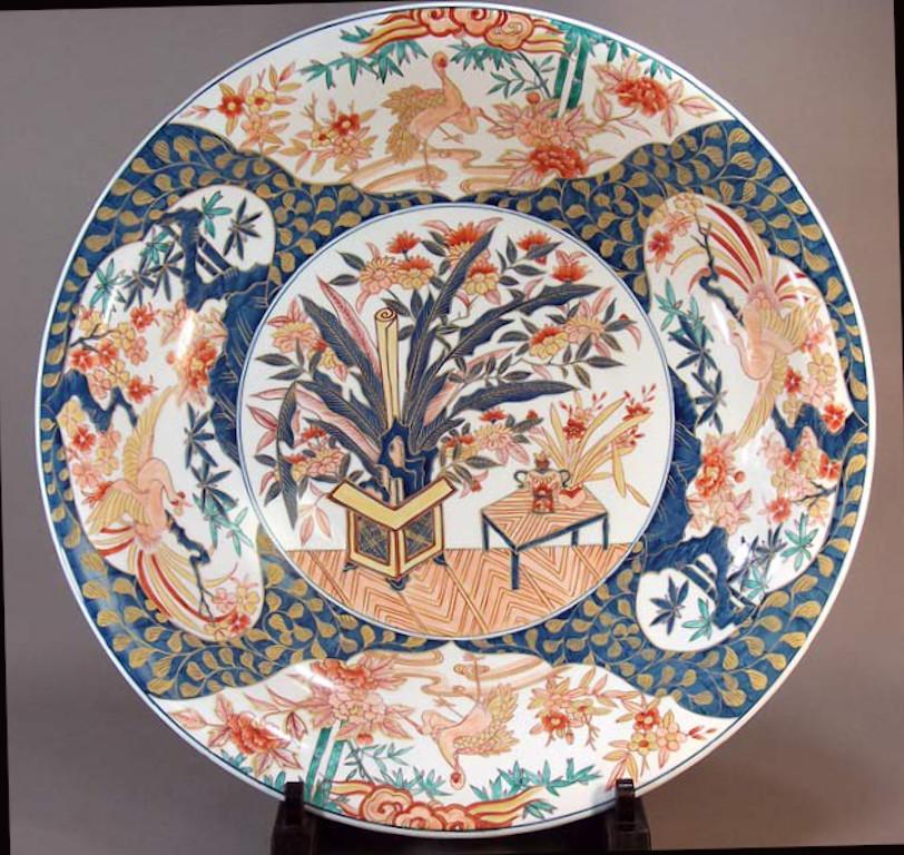 Exquisite contemporary Japanese Ko-Imari style very large decorative porcelain charger, hand painted in gold, blue, pink and red, a signed masterpiece by highly acclaimed award-winning master porcelain artist of the Imari-Arita region of Japan. In