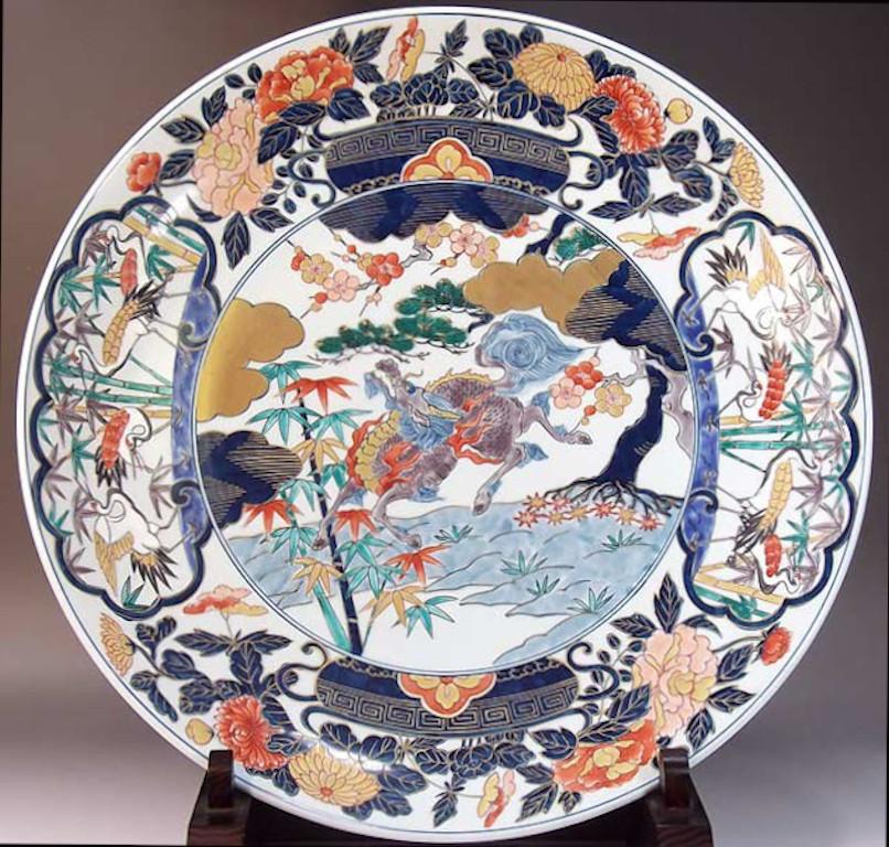 Exceptional contemporary Japanese Ko-Imari style large decorative porcelain charger, hand painted in gold, blue, green, pink, cream and red, a signed masterpiece by widely acclaimed award-winning master porcelain artist of the Imari-Arita region of
