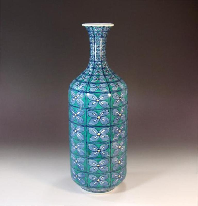 Japanese contemporary Imari Porcelain vase featuring a “flowers-in-the-wind” motif, hand-painted in blue, white and green.This elegantly shaped porcelain vase is a signed piece by a widely respected master porcelain artist of the Imari-Arita region