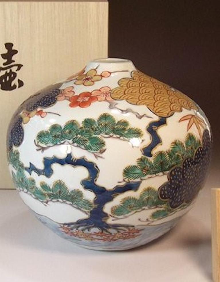 Exquisite contemporary Japanese porcelain vase, hand painted in green, blue, red and brown on a stunningly shaped porcelain body, a signed masterpiece by highly acclaimed award-winning master porcelain artist of the Imari-Arita region of Japan. In