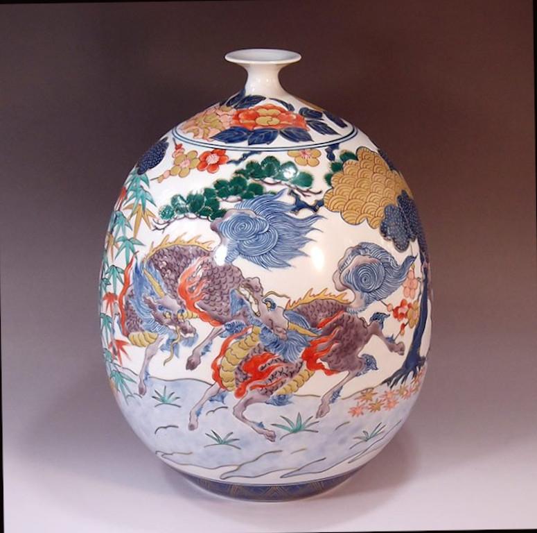 Exquisite contemporary Japanese porcelain vase, hand painted in green, blue and red on a stunningly shaped porcelain body, a signed piece by highly acclaimed award-winning master porcelain artist of the Imari-Arita region of Japan. In 2016, the