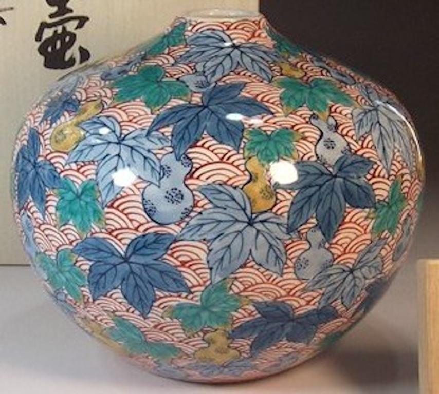 Contemporary Japanese porcelain decorative vase hand painted in green, red and blue on a beautifully shaped body, a signed work by highly acclaimed Japanese master porcelain artist in Imari-Arita tradition of Japan, and recipient of numerous awards