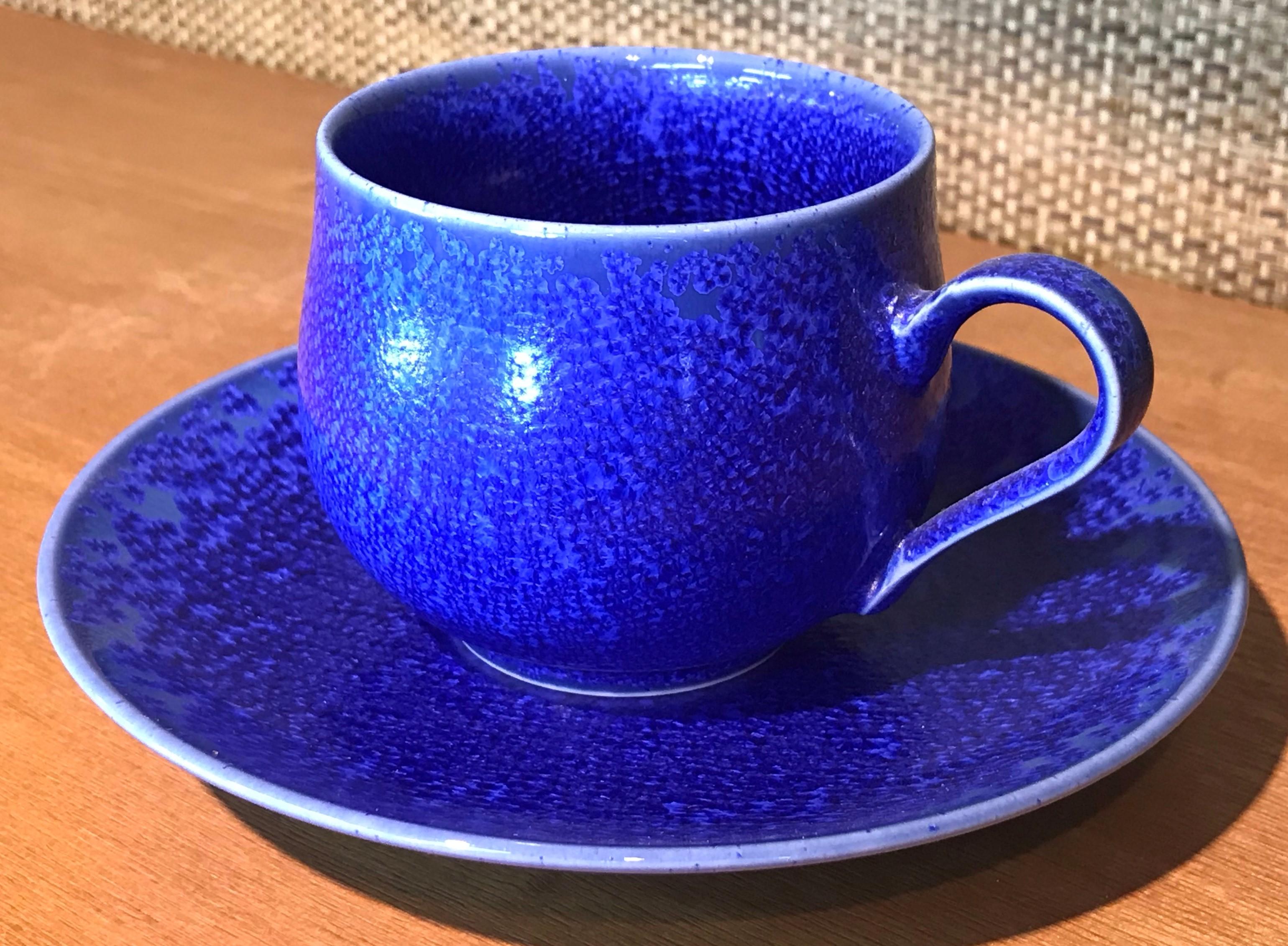 Exquisite Japanese contemporary porcelain cup and saucer, hand-glazed in striking signature royal blue, a signed work by highly acclaimed award-winning master porcelain artist from the Imari-Arita region of Japan. 

In this extraordinary piece, a
