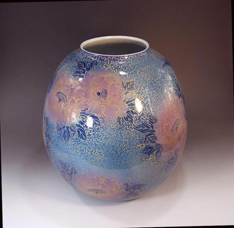 Large Japanese decorative porcelain decorative vase, hand painted in beautiful shades of blue, pink with intricate gold details on an elegantly shaped ovoid porcelain body, a signed work by widely acclaimed Japanese master porcelain artist in the