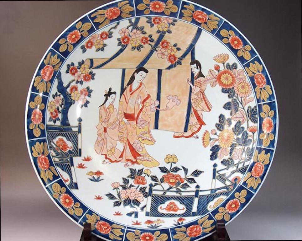 Exquisite contemporary Japanese large decorative porcelain charger, hand painted in blue, pink and red, a signed masterpiece by widely respected award-winning master porcelain artist of the Imari-Arita region of Japan. In 2016, the British Museum