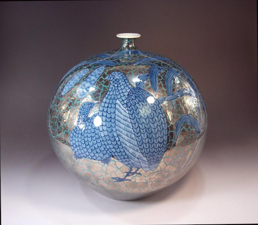 Contemporary Japanese porcelain decorative vase, hand painted in underglaze cobalt blue set against a stunning cracked background in platinum, an elegantly shaped globular porcelain body. It is a signed piece by highly respected award-winning master