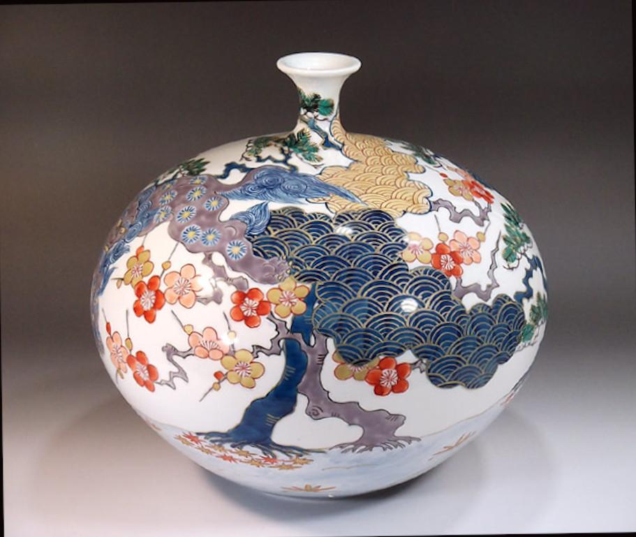 Unique contemporary Japanese porcelain decorative vase, intricately hand painted in blue, purple, green and red on an elegantly shaped ovoid porcelain body, a signed work by widely respected Japanese master porcelain artist in the Imari-Arita