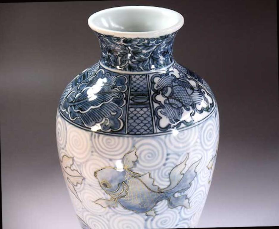 Japanese porcelain decorative vase, hand painted in beautiful shades of blue on an elegantly shaped ovoid porcelain body, a signed piece by widely acclaimed Japanese master porcelain artist in the Imari-Arita tradition. In 2016, the British Museum