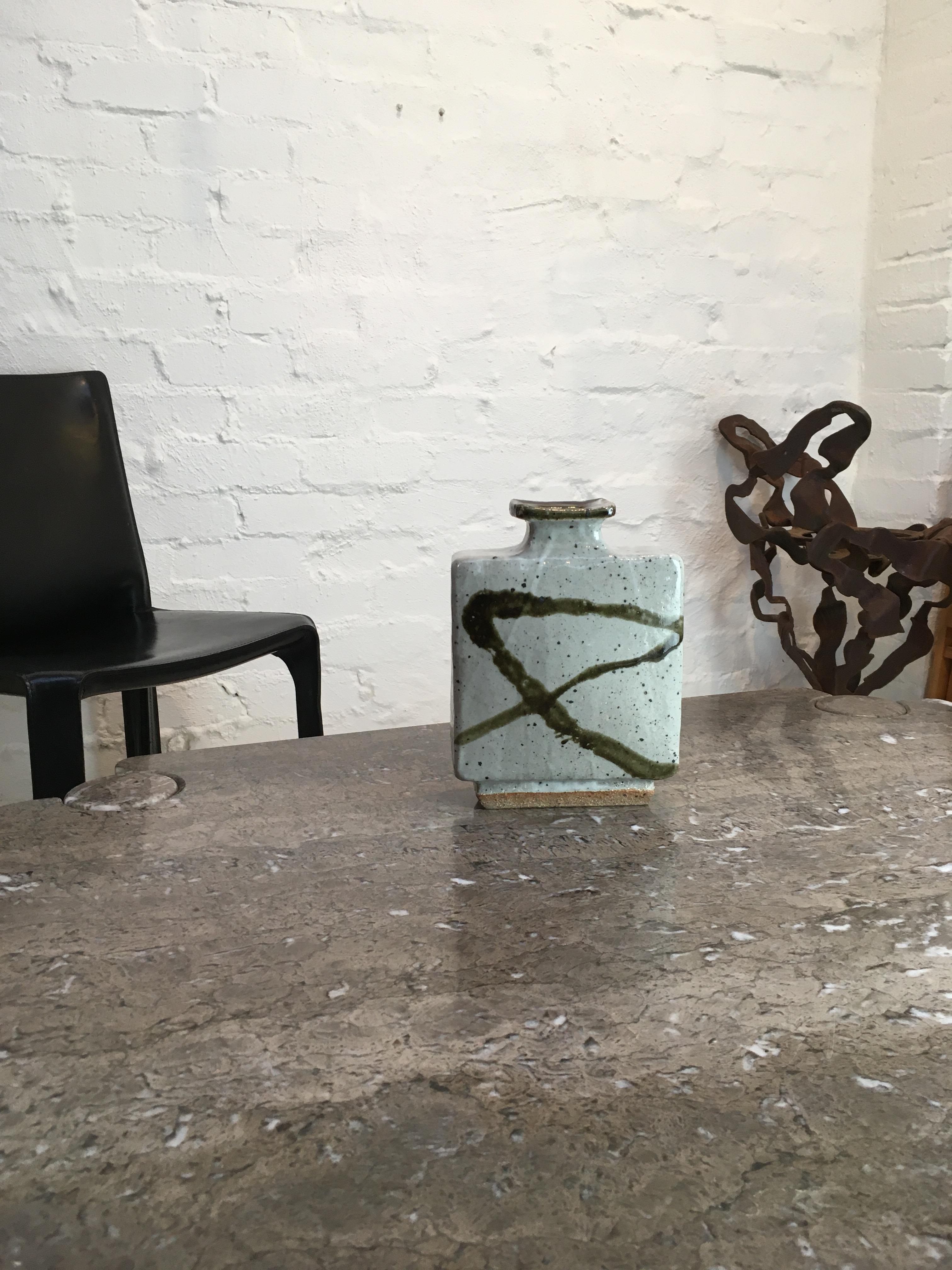 This beautifully crafted slab vase in the Japanese style was made during Les Blakebrough’s directorship of the Sturt workshops at Mittagong, New South Wales, after his return from study in Japan under Takeichi Kauai. 

It carries the Sturt stamp