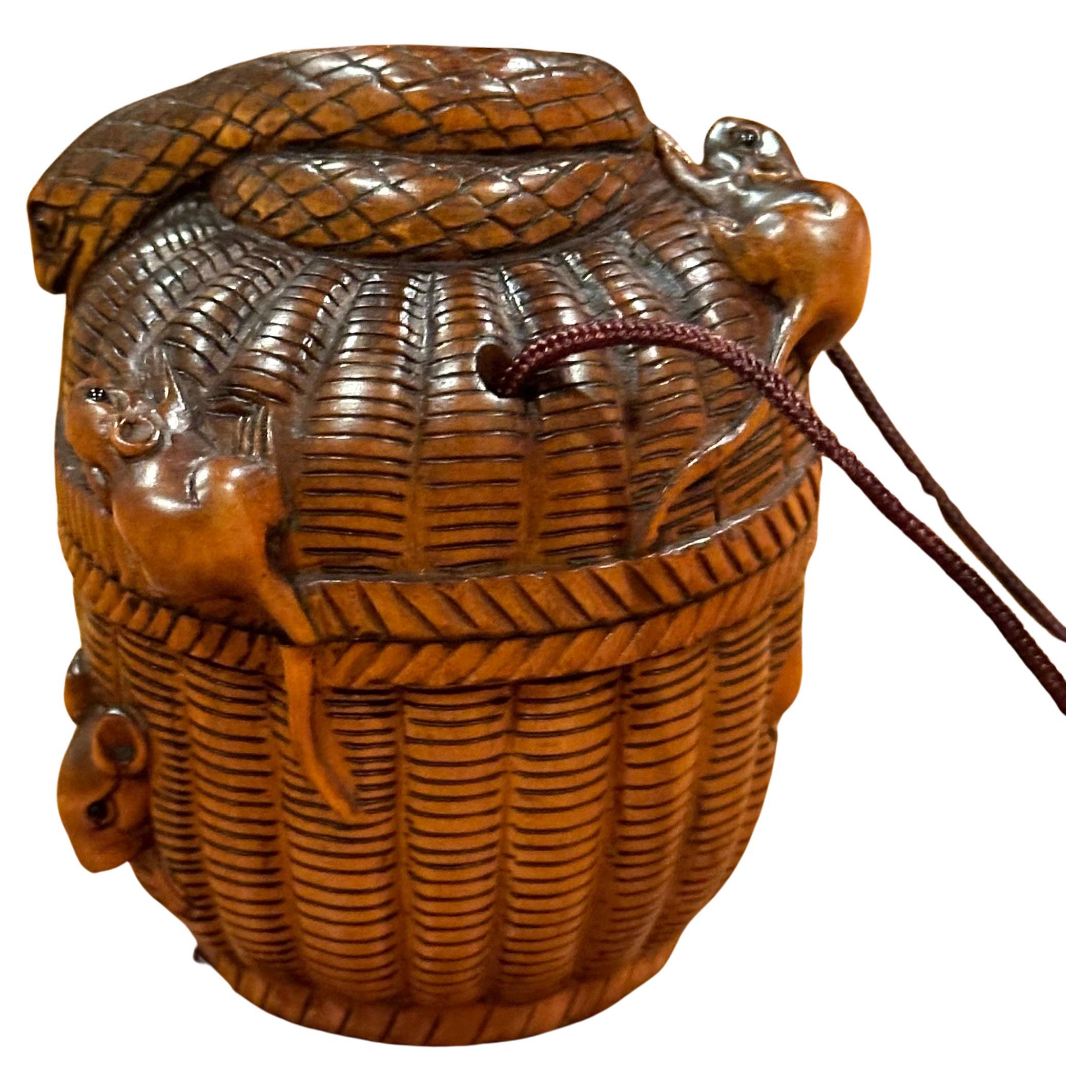 A really nice vintage Japanese boxwood inro and netsuke of rats and snakes on a round basket, circa early 1940s.  The piece is well carved with wonderful detail and in very good vintage condition; it includes a small rat netsuke.  The piece measures