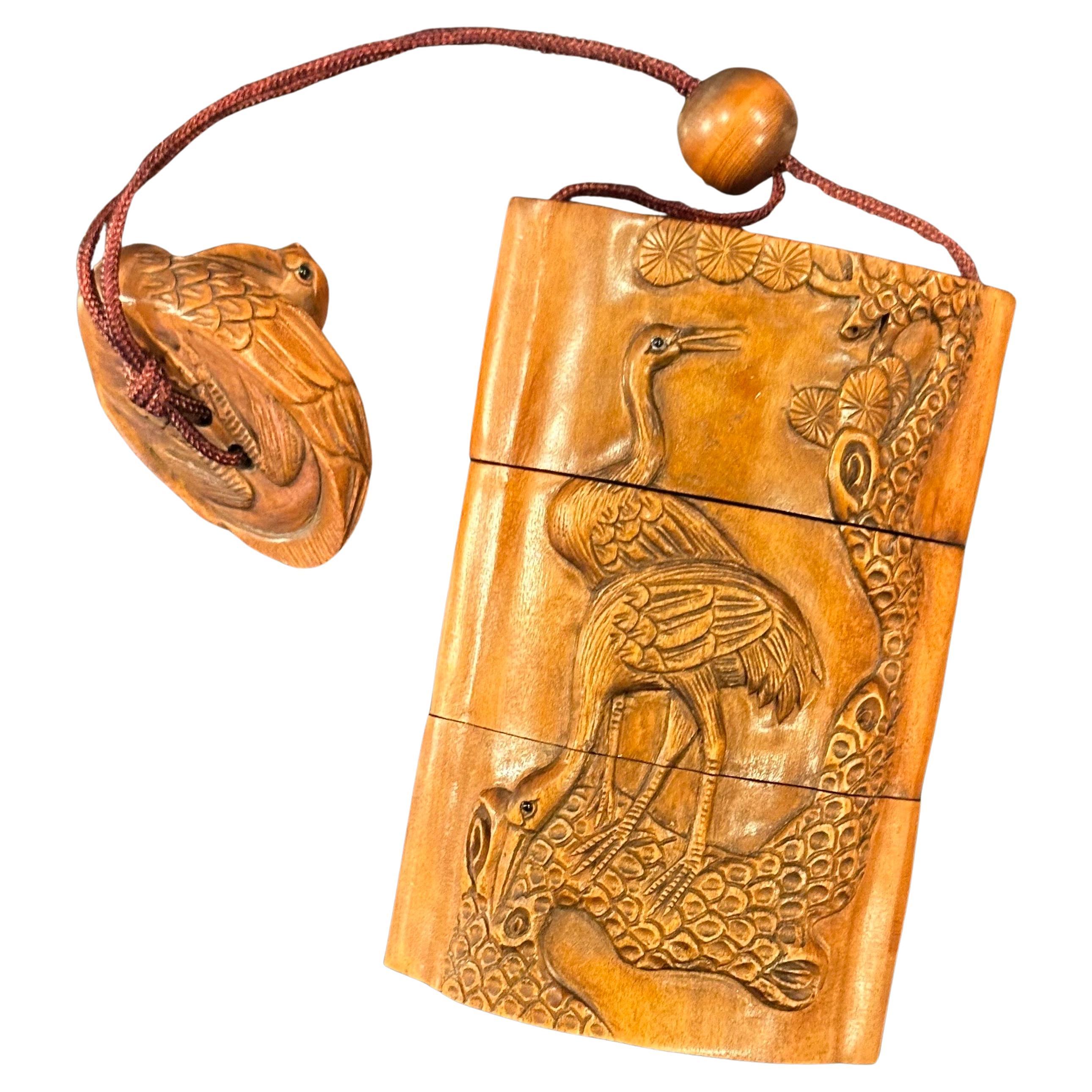 A really nice vintage Japanese boxwood three-section inro and netsuke of cranes by Tomotada, circa early 1900s.  The piece is well carved with wonderful detail and in very good vintage condition; it includes a small crane netsuke.  The piece