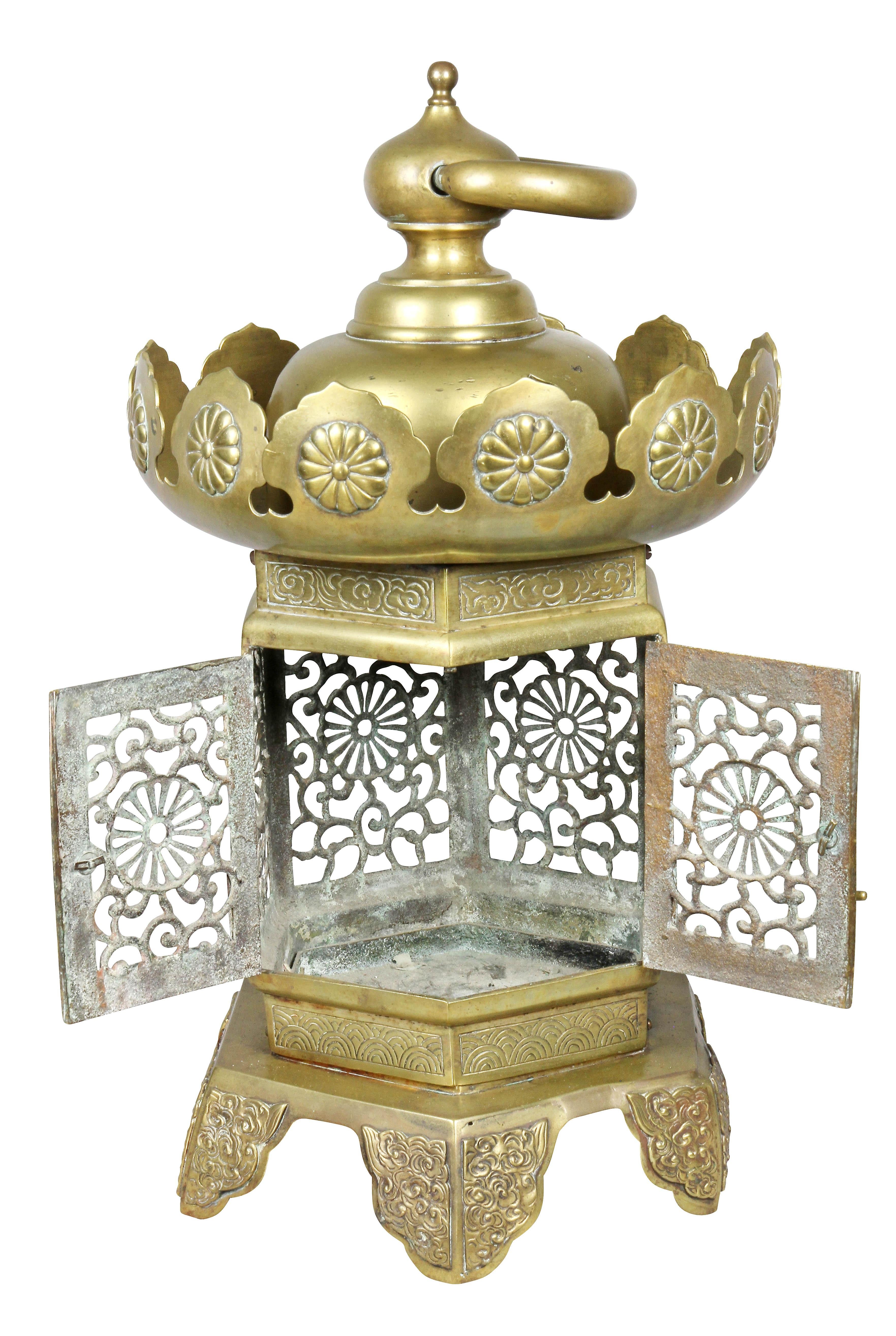 With ring finial and pagoda top with chrysanthemum rosettes, open grillwork lantern area, four shaped feet. Provenance; C.T Loo.