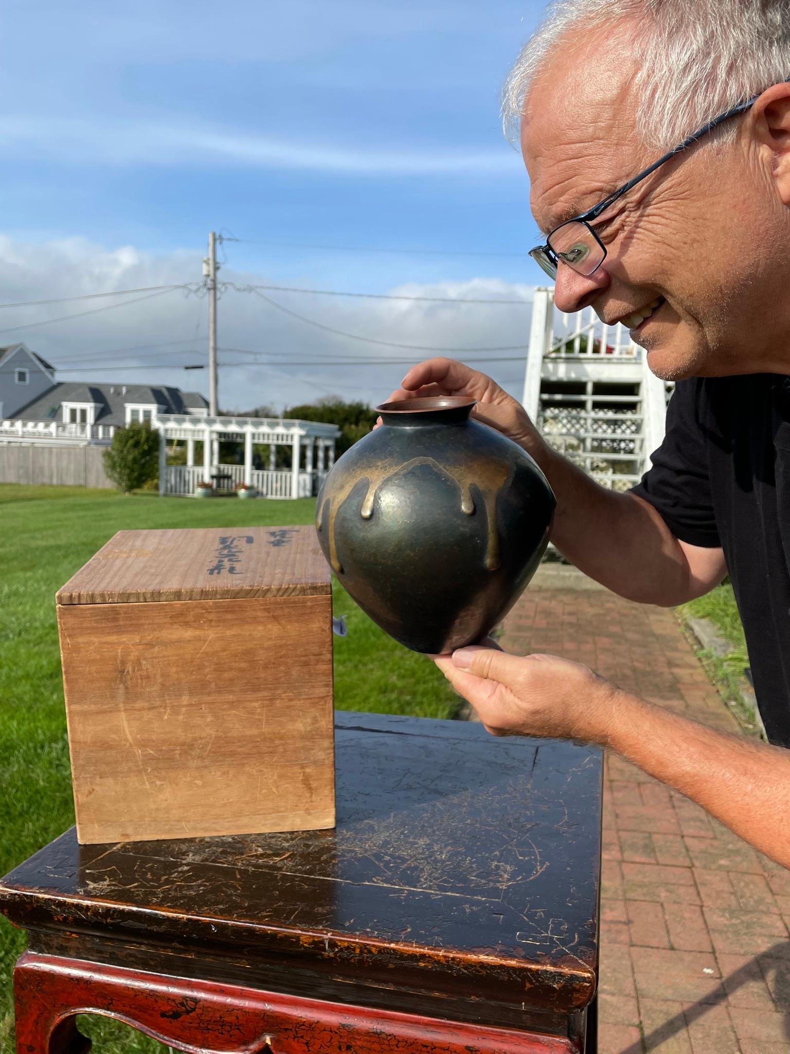 From Our Recent Japanese Acquisitions

From Japan comes this attractive hand hammered and drip glazed cast copper vase with a special hand applied surface glazing that we rarely encounter today. It is signed on its base and is accompanied by its