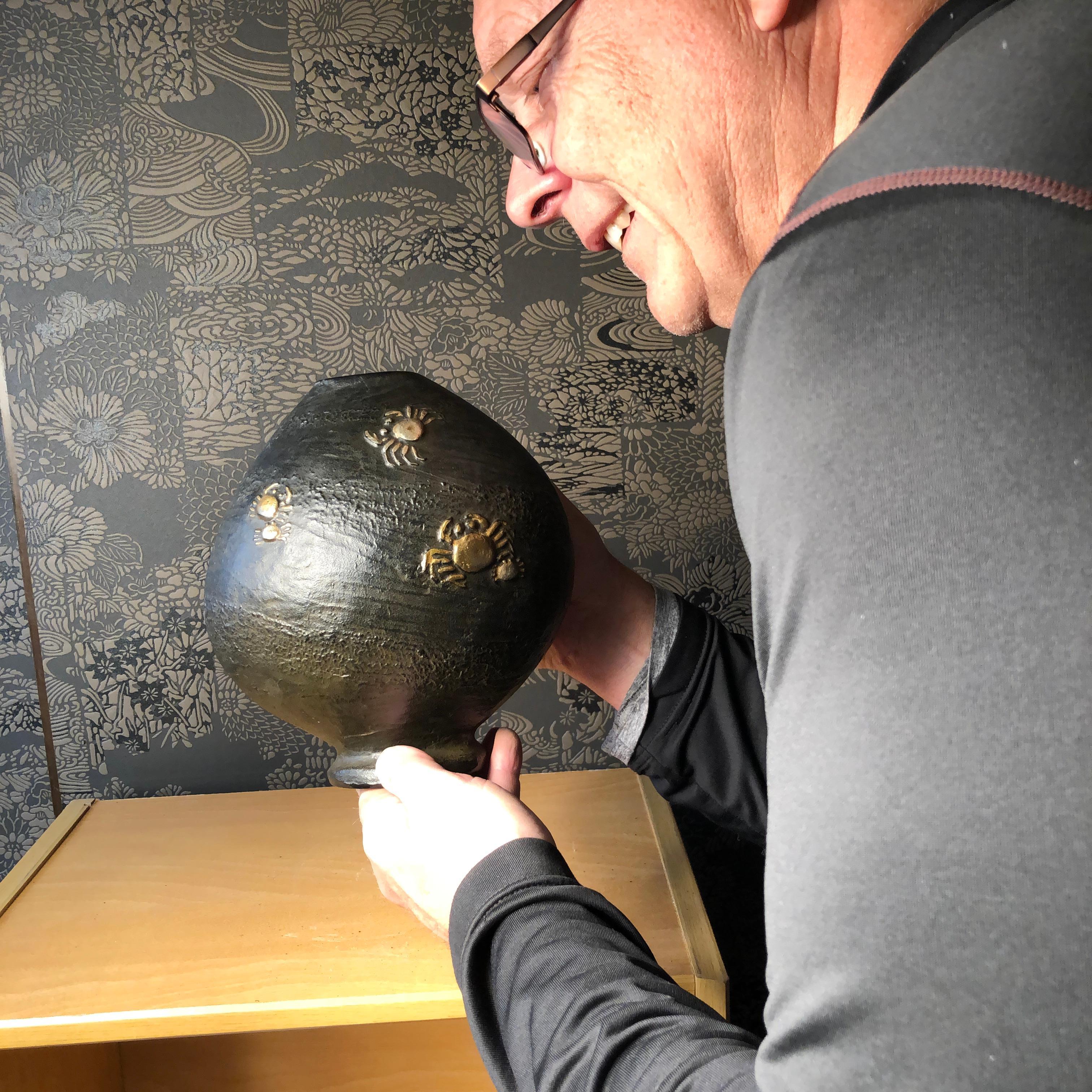 From our recent Japanese Travel Acquisitions

Mint and boxed

A fine tall ovoid form Japanese hand cast bronze nautical vase highlighted in silver and gold with a school of fish on one side and scurrying crabs on the other- all creatures seeming