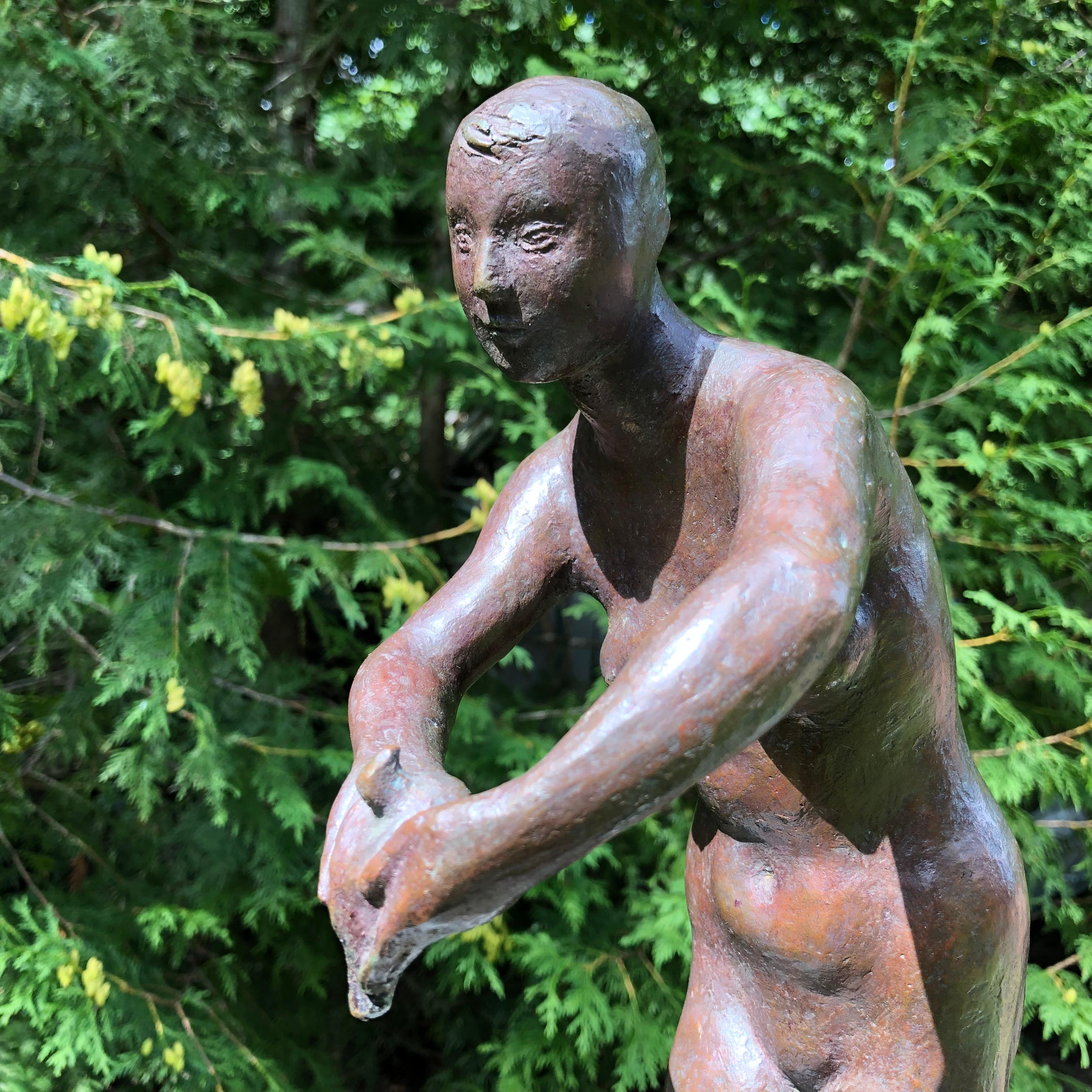 Japan a lovely, sensitive cast bronze sculpture of a woman gently holding a dove in her hands. The naive female nude by a midcentury sculptor. 

This is a Classic midcentury nude female pose with the artist's signature on base. 

The bonus