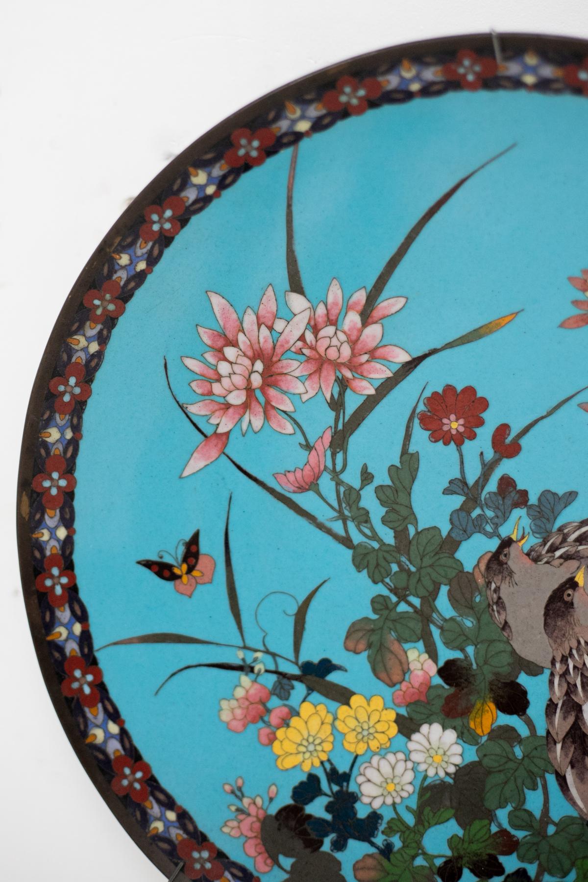 A bronze and cloisonné enamel round plate designed in Japan at the end of the 19th century, during the 'Meiji' era, which can be translated as 'enlightened government'. This historical period in Japan was marked by the rule of Emperor Mutsuhito and