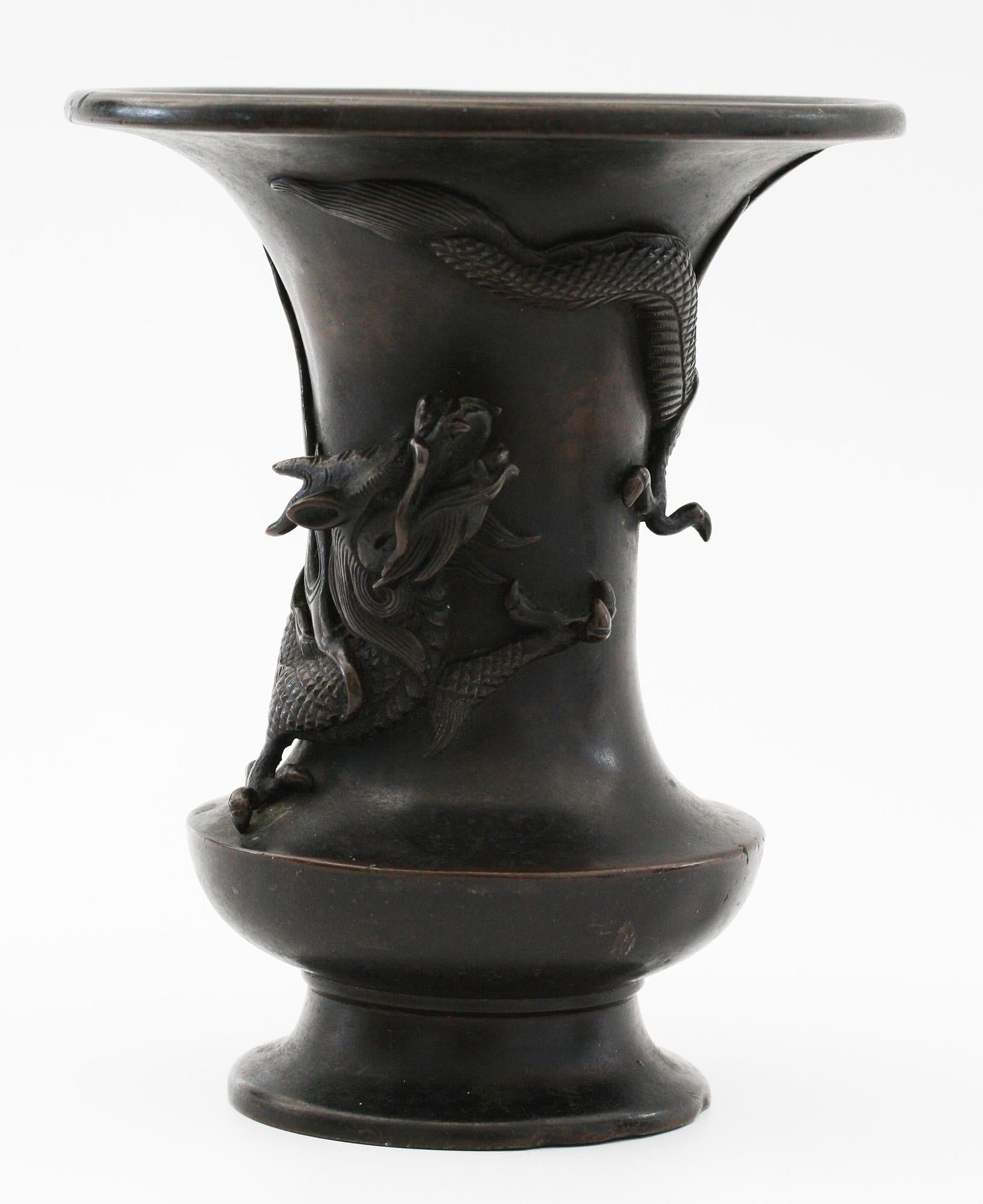 A stunning antique Japanese late Edo or early Meiji period campana shaped bronze vase applied with a scrolling dragon believed to date from the Edo or early Meiji period. The vase is well executed and heavily made with superb craftsmanship and