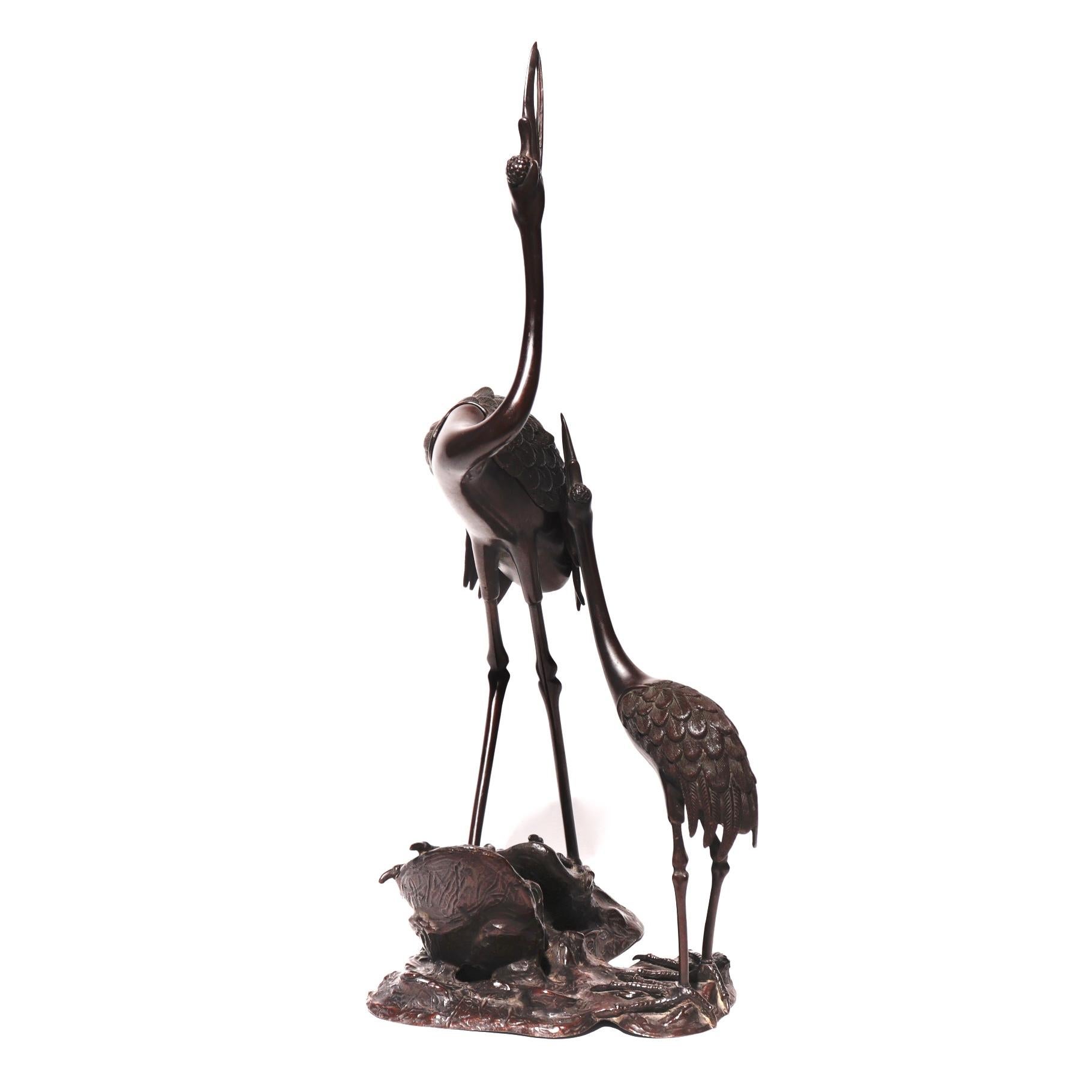 Japanese bronze incense burner in the unusual form of two cranes on a rocky outcropping each standing with necks outstretched to the heavens, the larger crane with removable wings serving as the censer cover. Signs of wear and use otherwise Fine